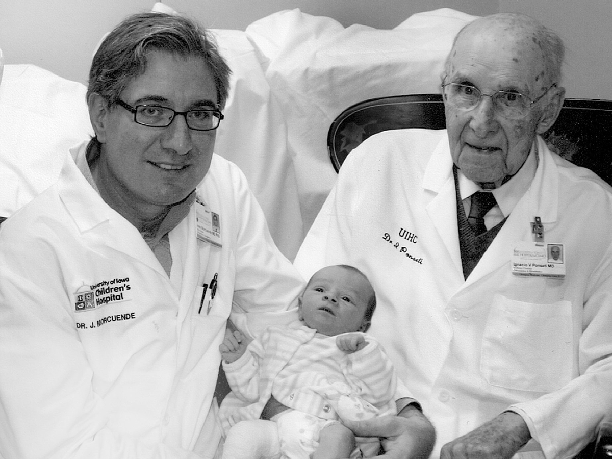 Like Ignacio Ponseti, UI pediatric surgeon Jose Morcuende came to Iowa from Spain for orthopedics training and found his calling healing children born with clubfoot. Here, Morcuende is pictured alongside his mentor and a young patient