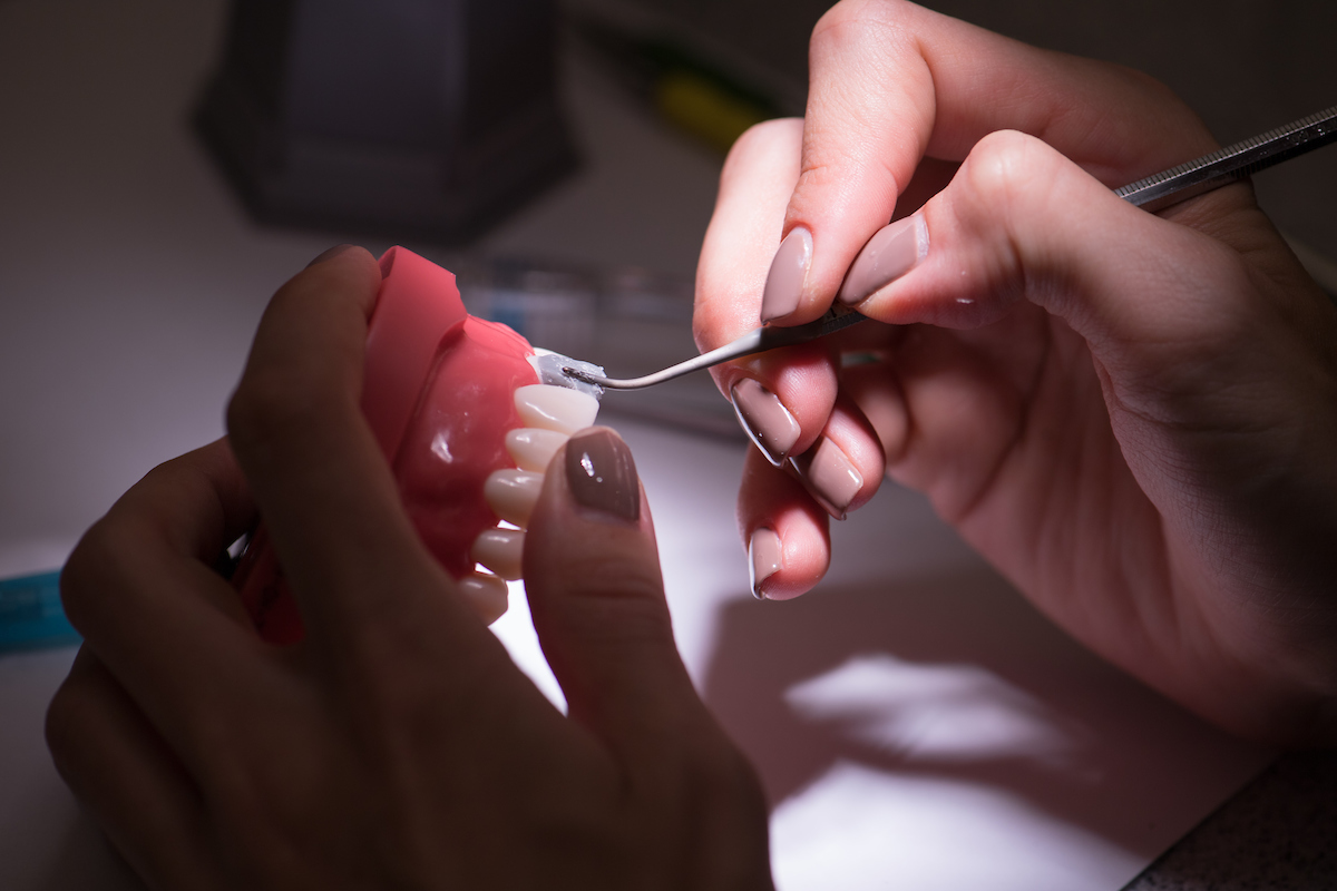 A student crafts a model tooth