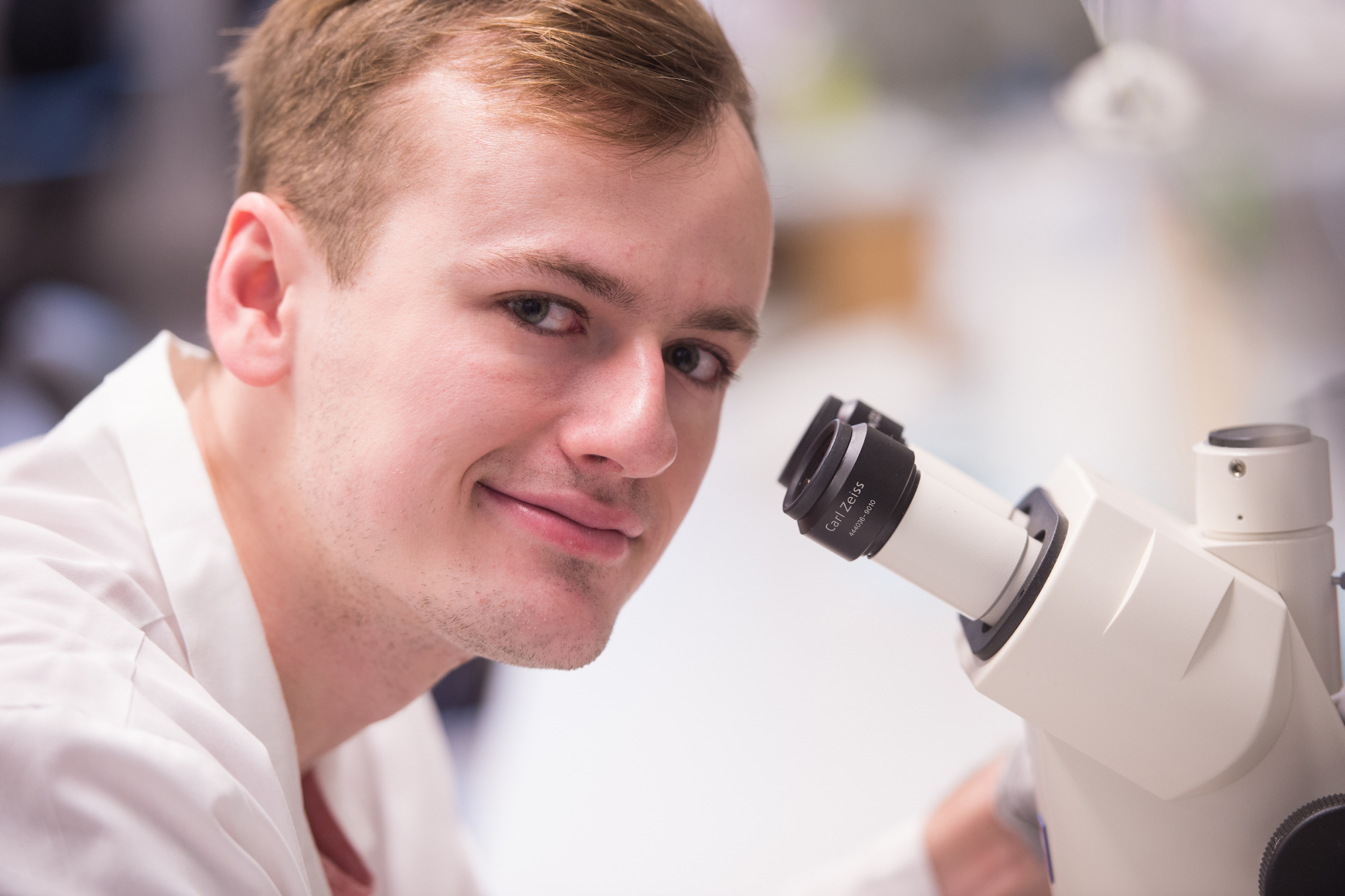 University of Iowa graduating senior Jesse Cochran looks away from his work for a photograph