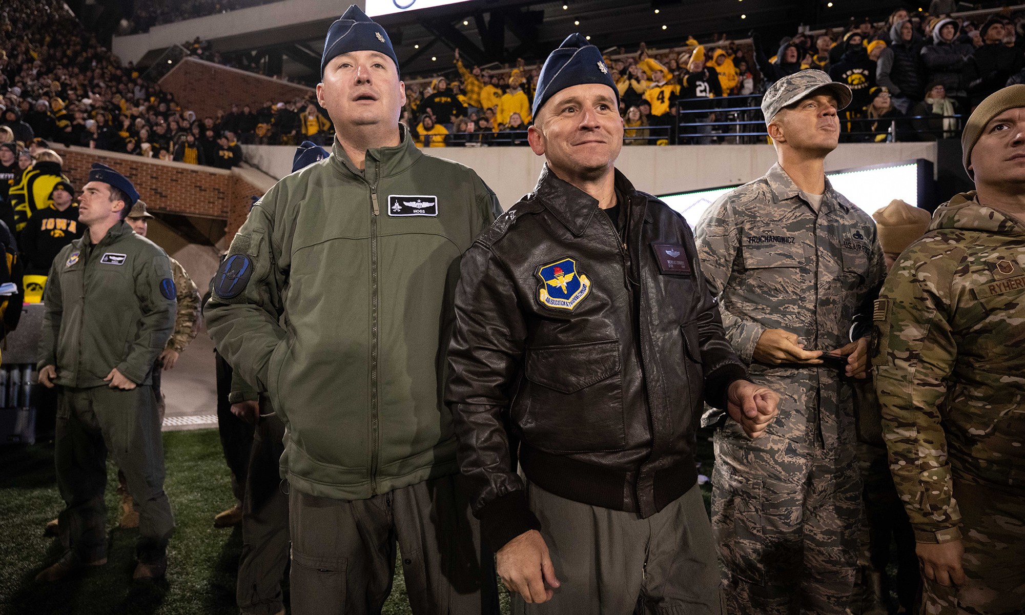 university of iowa alumni Lt. Col. Michael Lynch and Lt. Col. Nicholas Edwards on the sidelines at Kinnick Stadium