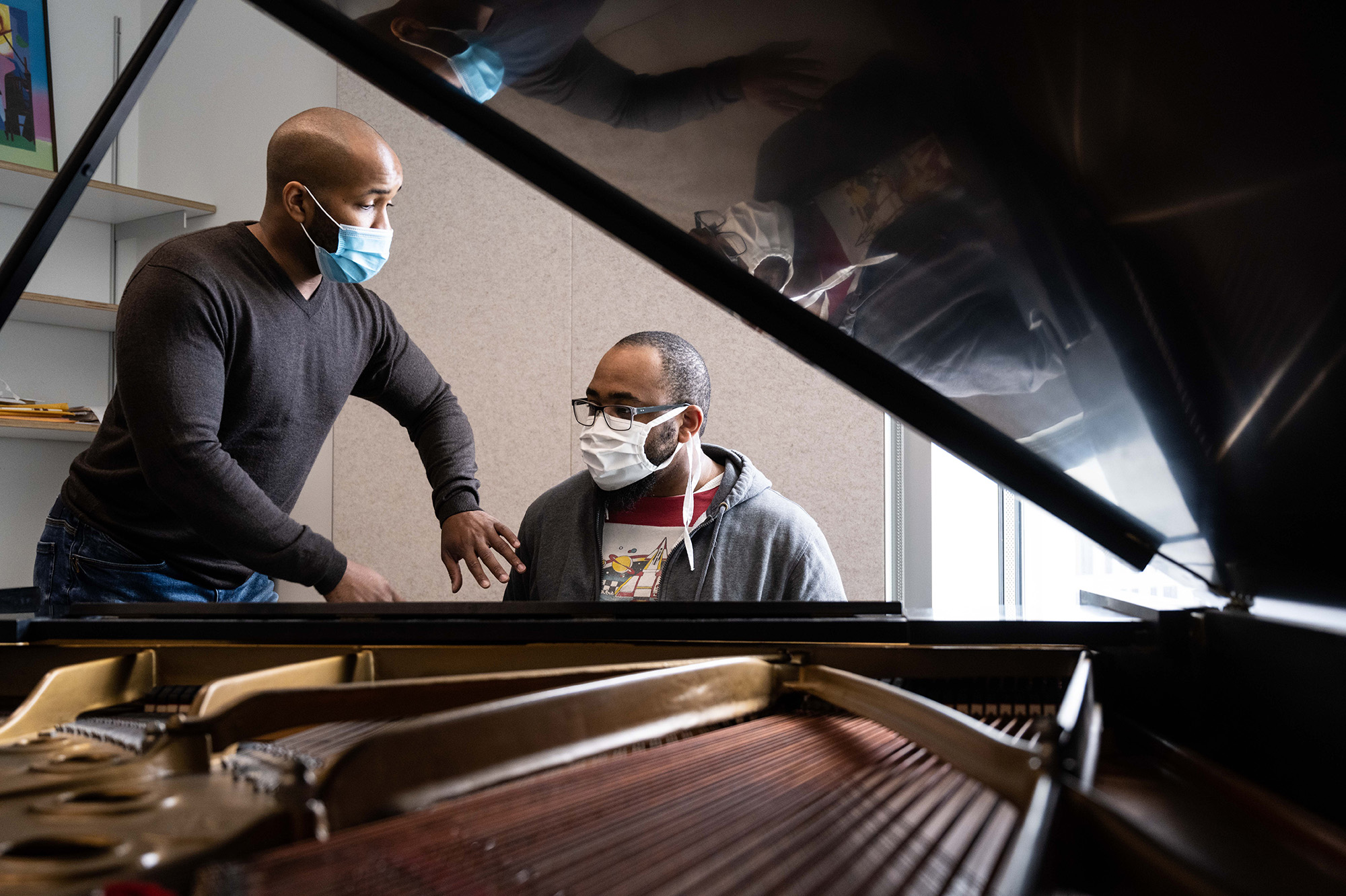 University of Iowa jazz studies faculty member William Menefield works with a student at a piano