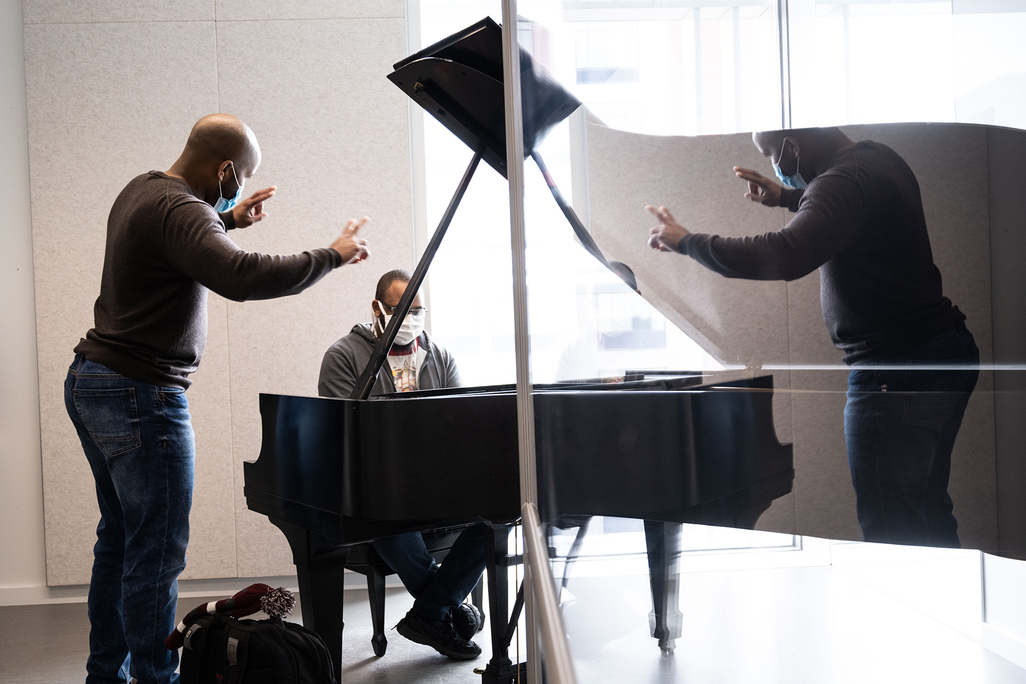 University of Iowa faculty member Dr. William Menefield works with a student in his office in the Voxman Music Building