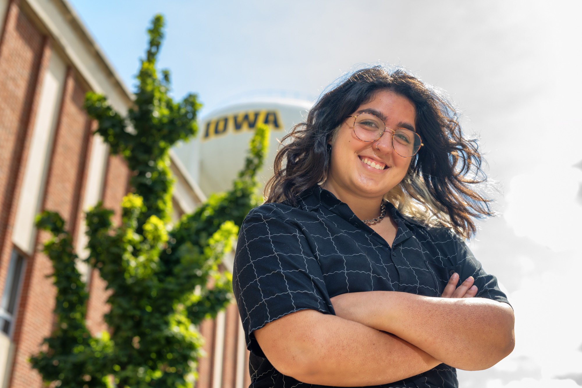 University of Iowa graduate student Bianca Robles-Munoz standing on the Iowa campus, near the Wendell Johnson Speech and Hearing Clinic