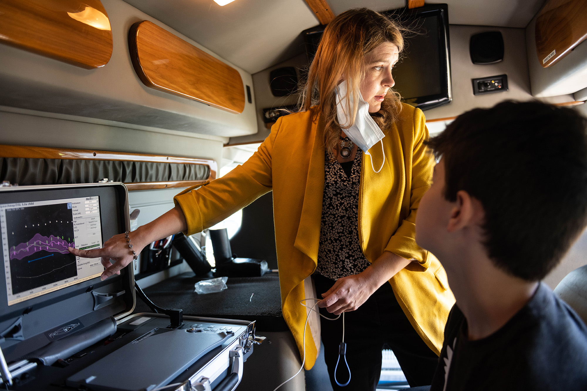 a university of iowa student conducts research with a child with hearing loss in a mobile research lab