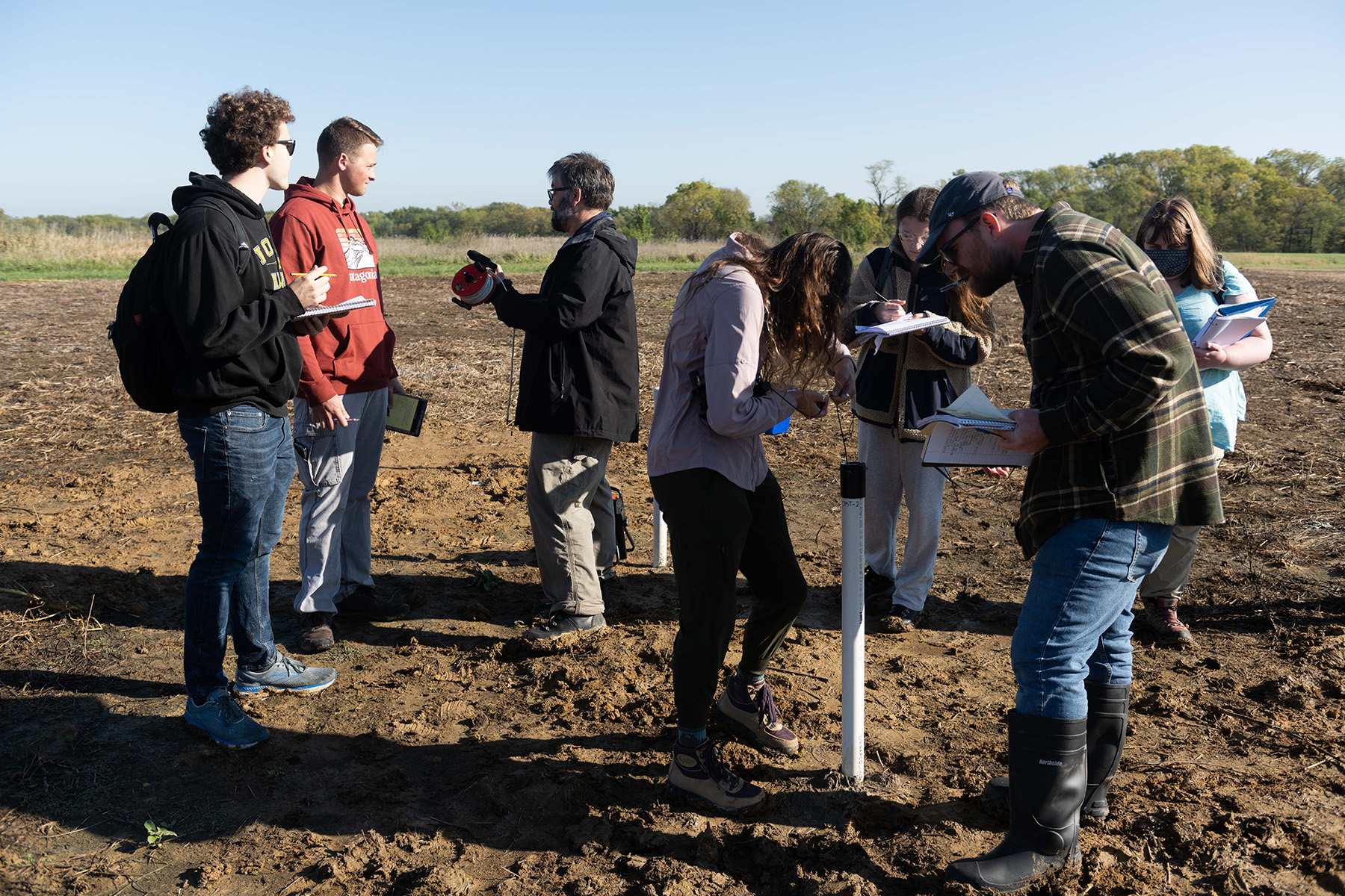 students in a field for a geology course