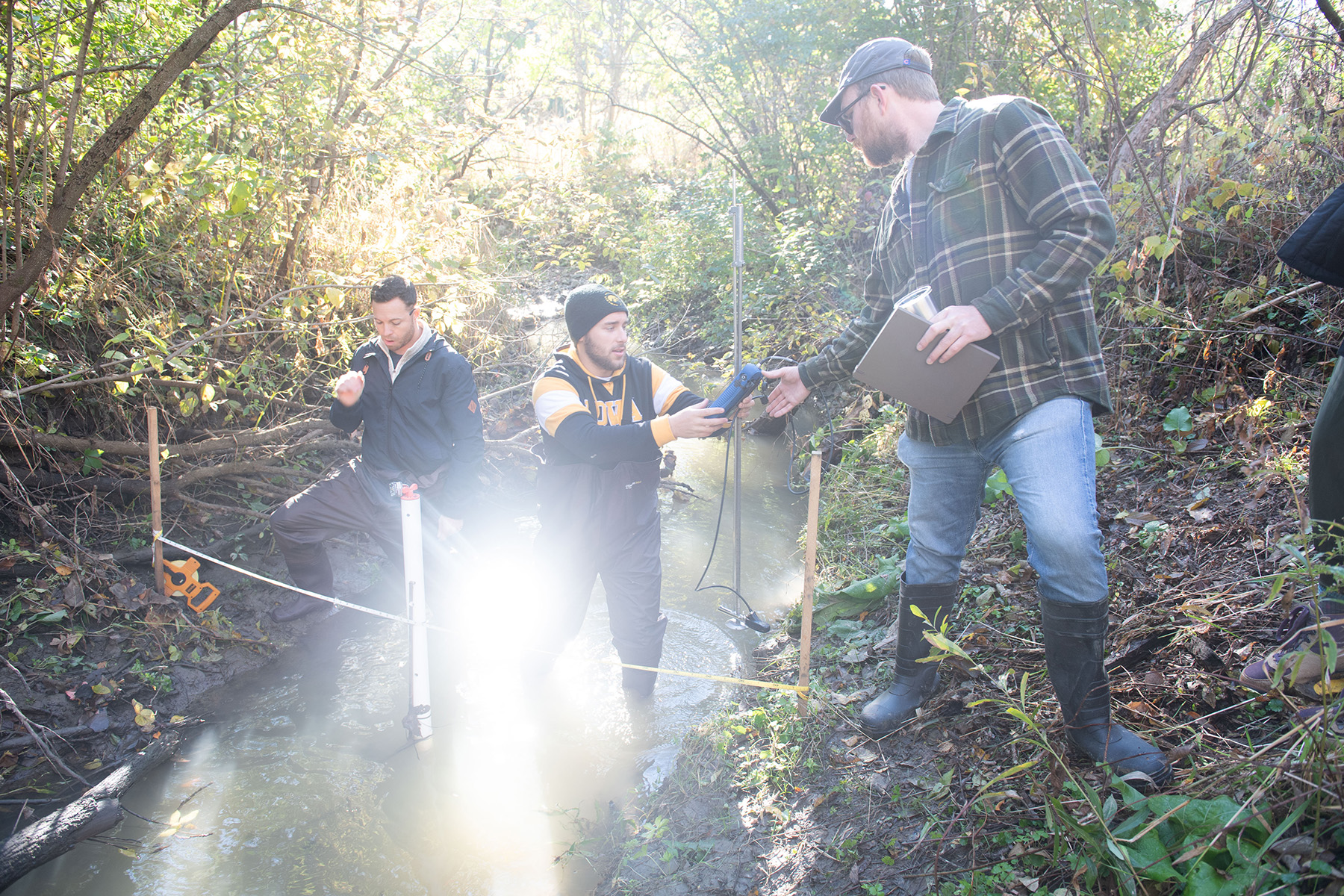 university of iowa students working in a stream