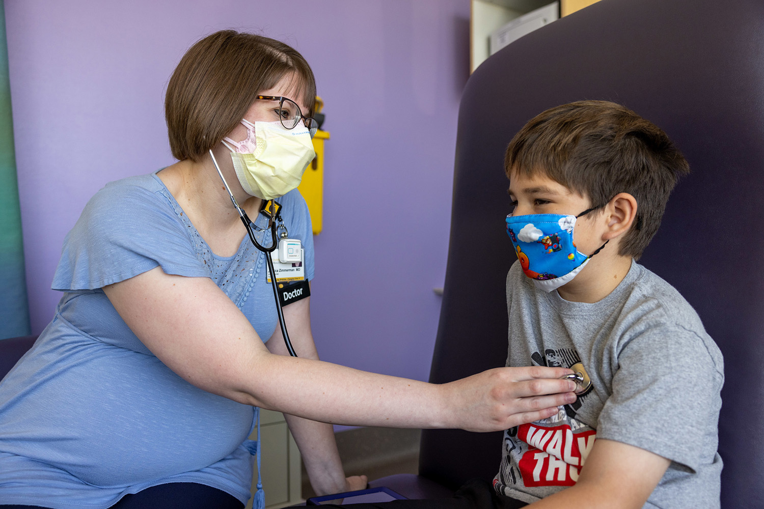 a health care professional examining a pediatric patient