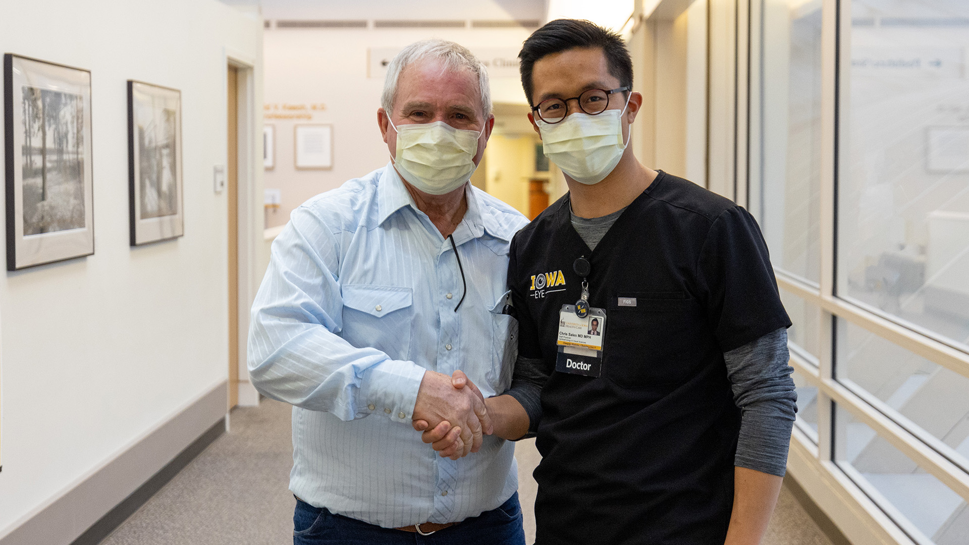 a man and a surgeon shaking hands in a medical clinic