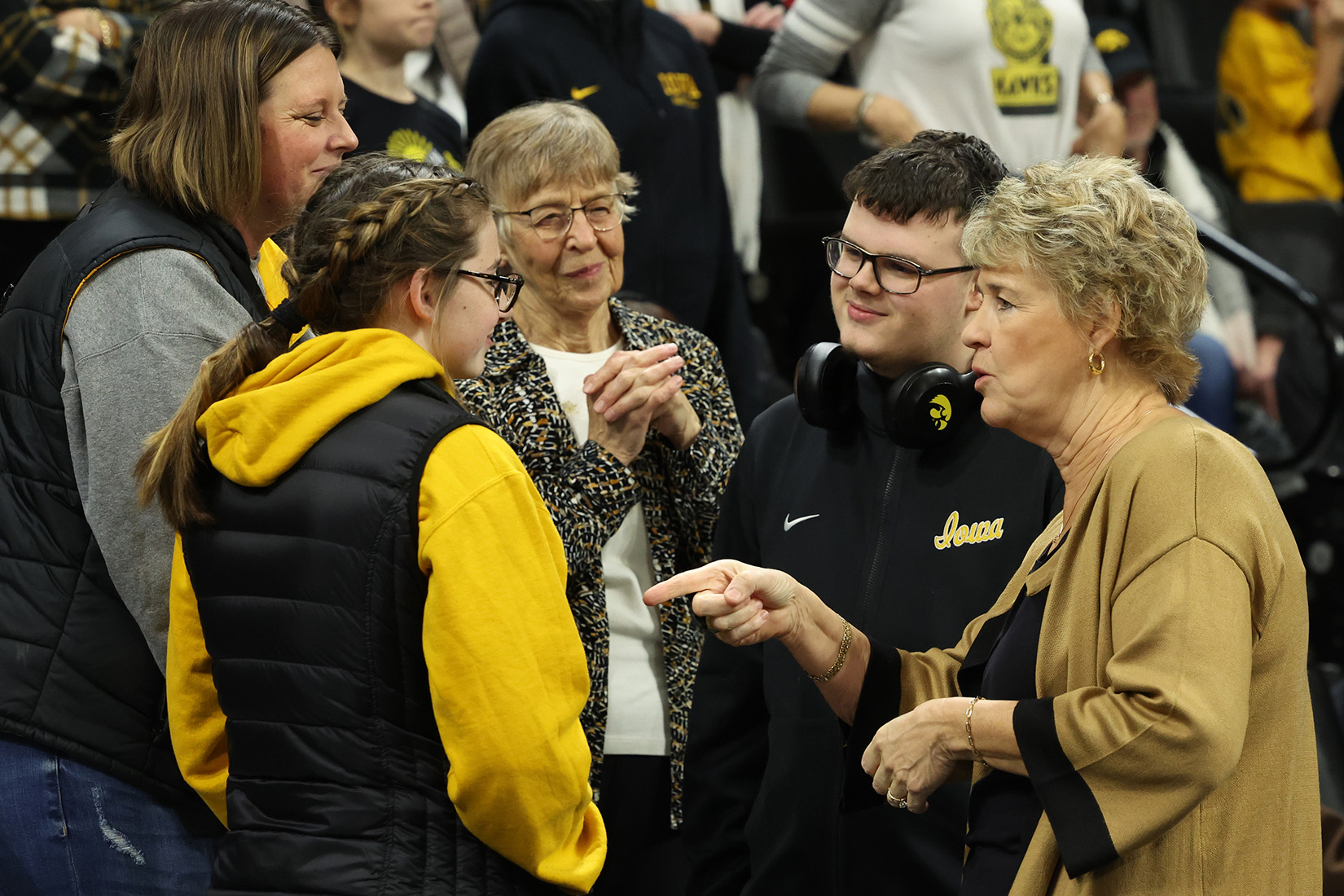 Cooper Reaves and Lisa Bluder visit with others at Carver-Hawkeye Arena