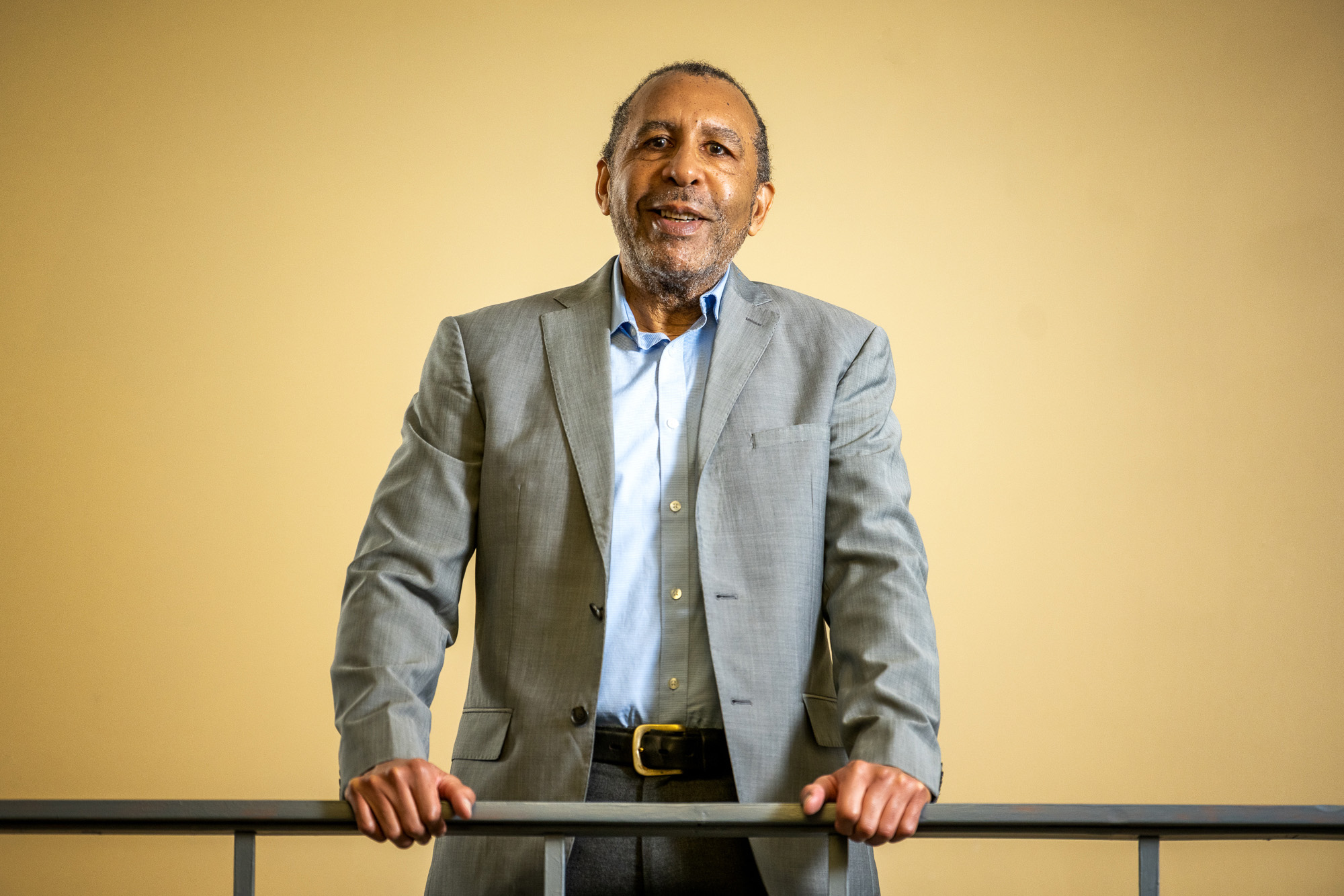 a man standing behind a railing