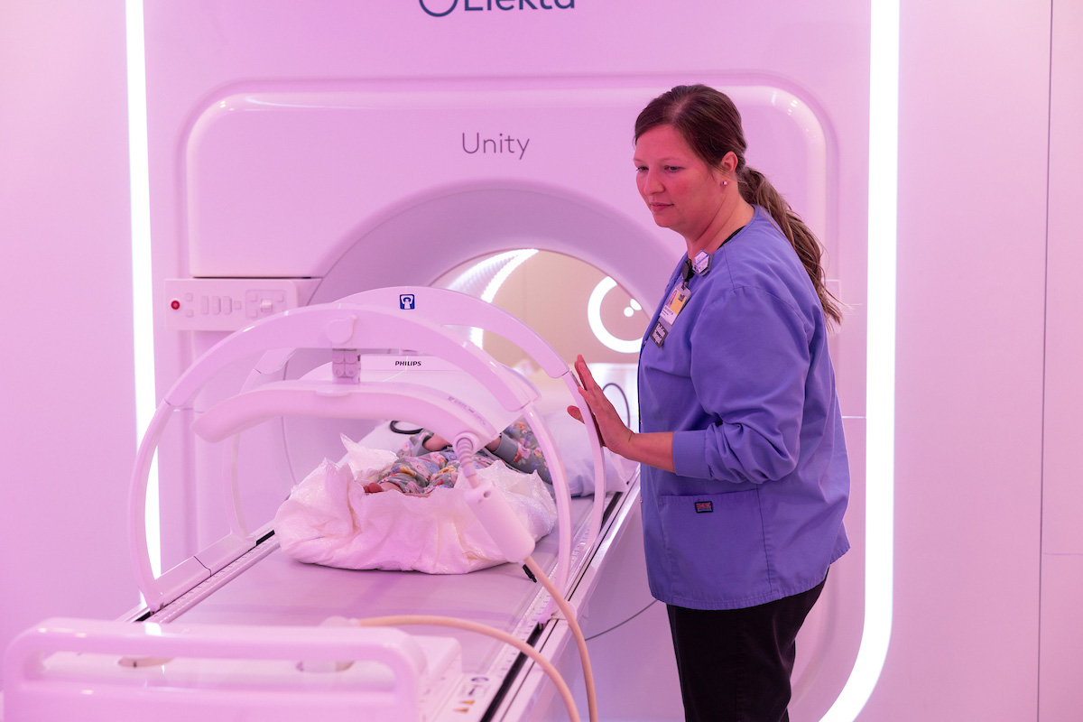 health care worker uses imaging equipment 