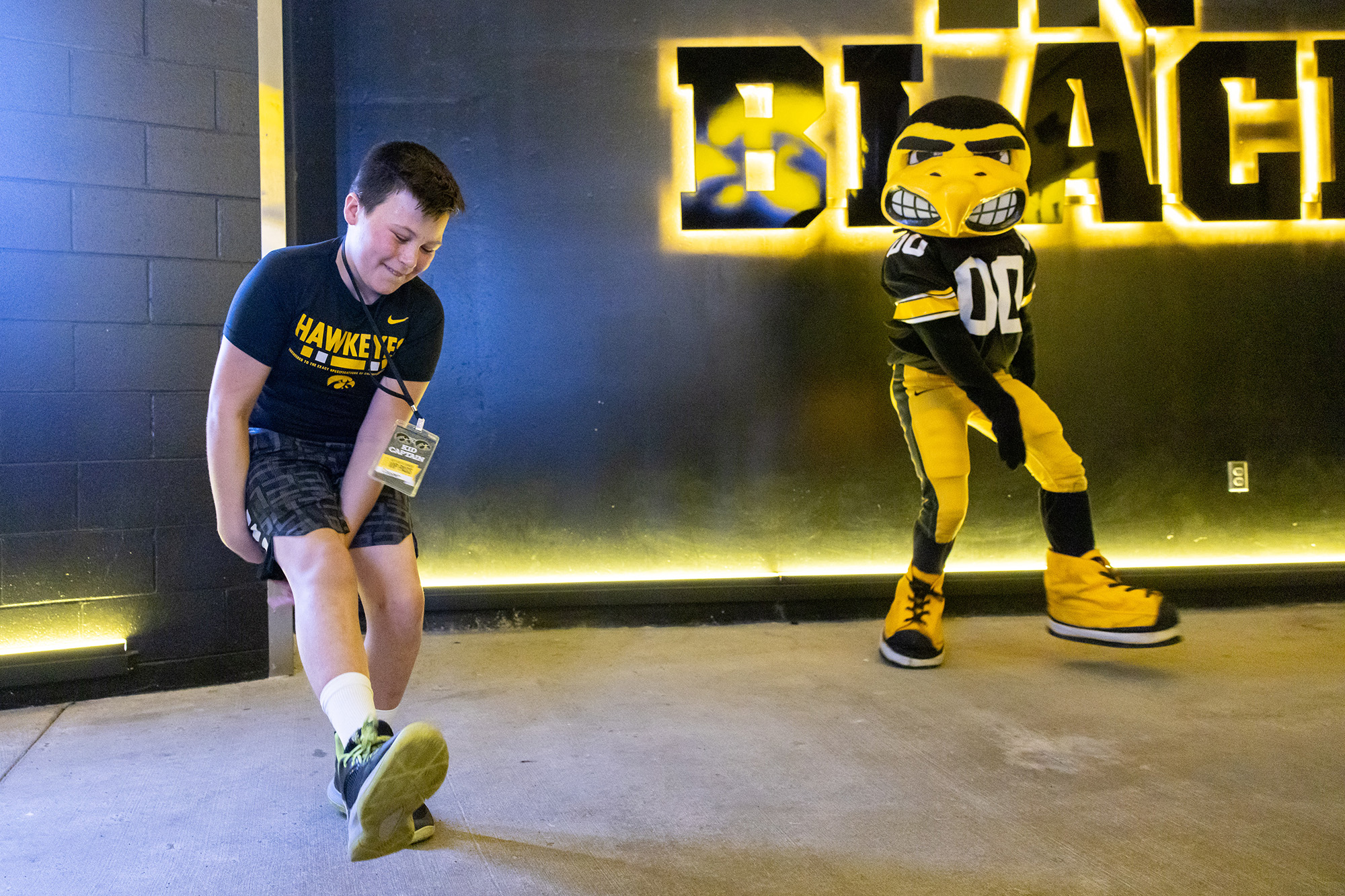 Kid Captain Cooper Estenson dancing with Herky at Kids Day at Kinnick