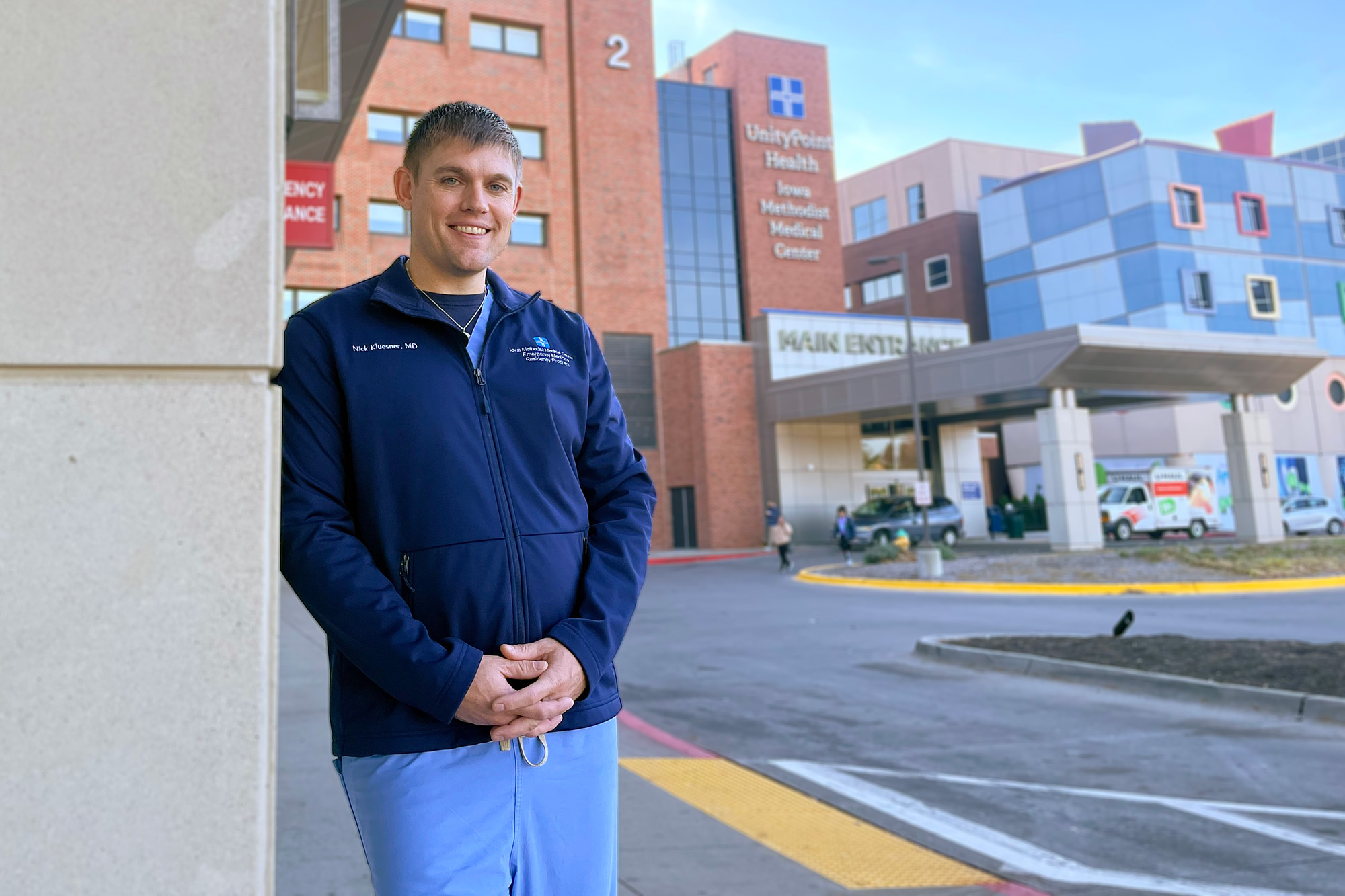 a doctor stands outside of a health care facility