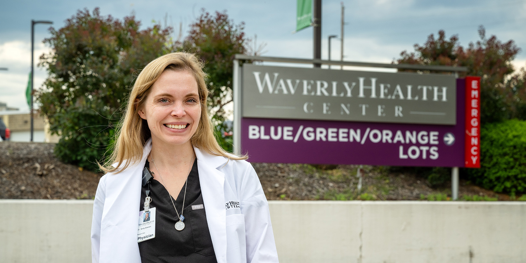 University of Iowa Carver College of Medicine grad Emily Boevers standing outside a medial facility in Waverly, Iowa