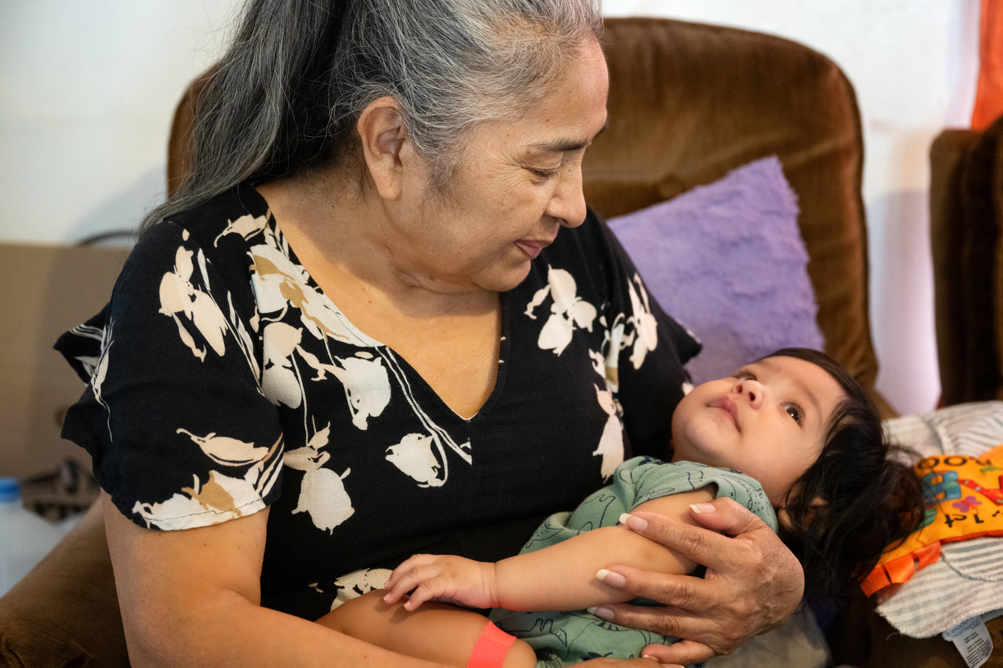 Maria Andrade holds one of her grandchildren