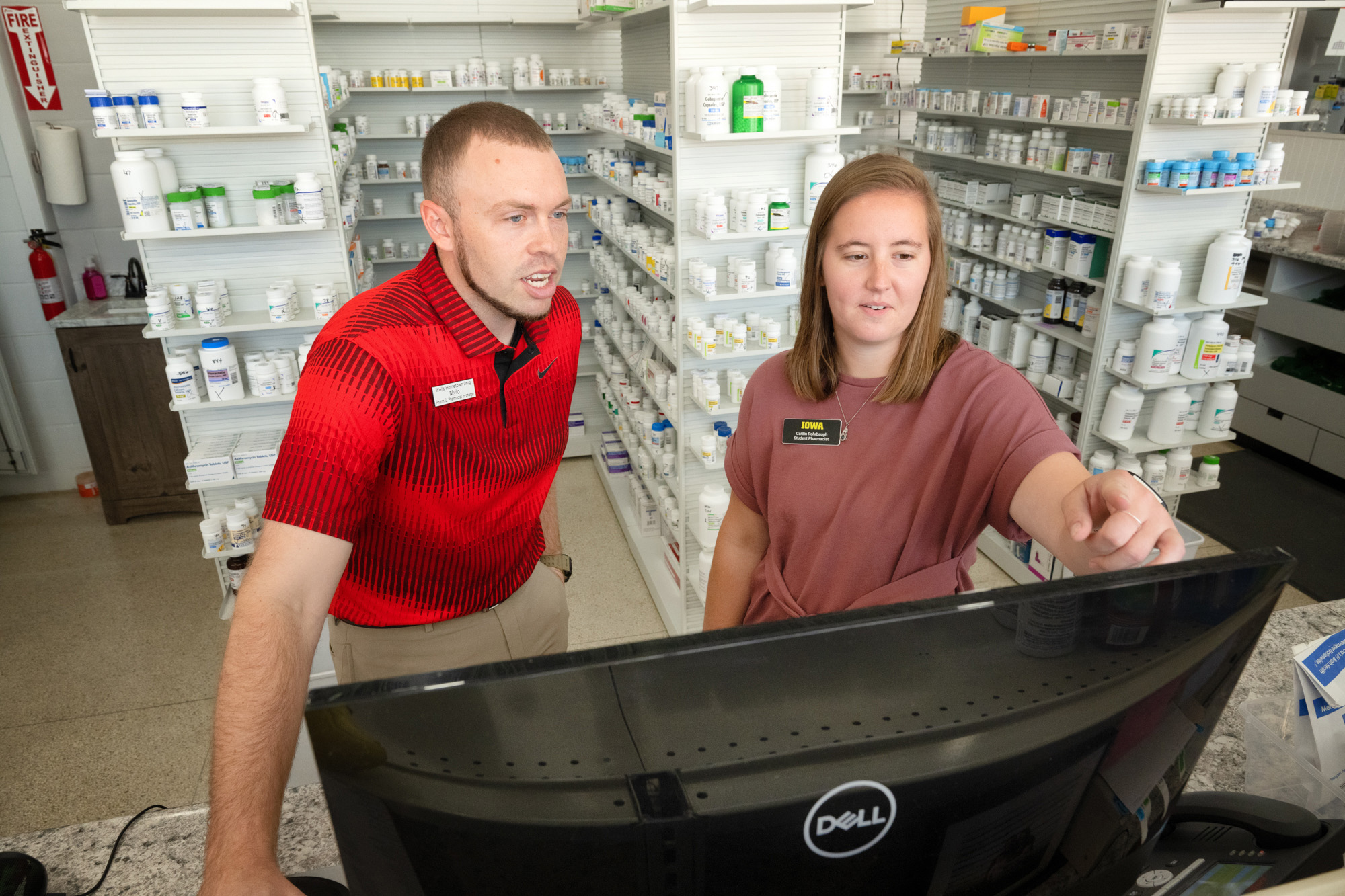 two people working inside a pharmacy