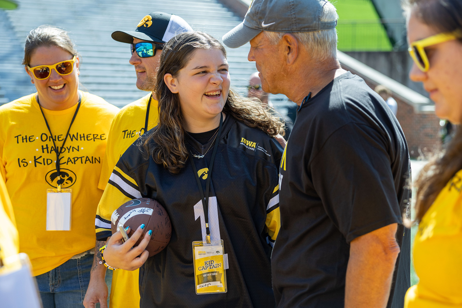 Kid Captain Haidyn Ulrich with Iowa head coach Kirk Ferentz at Kinnick Stadium