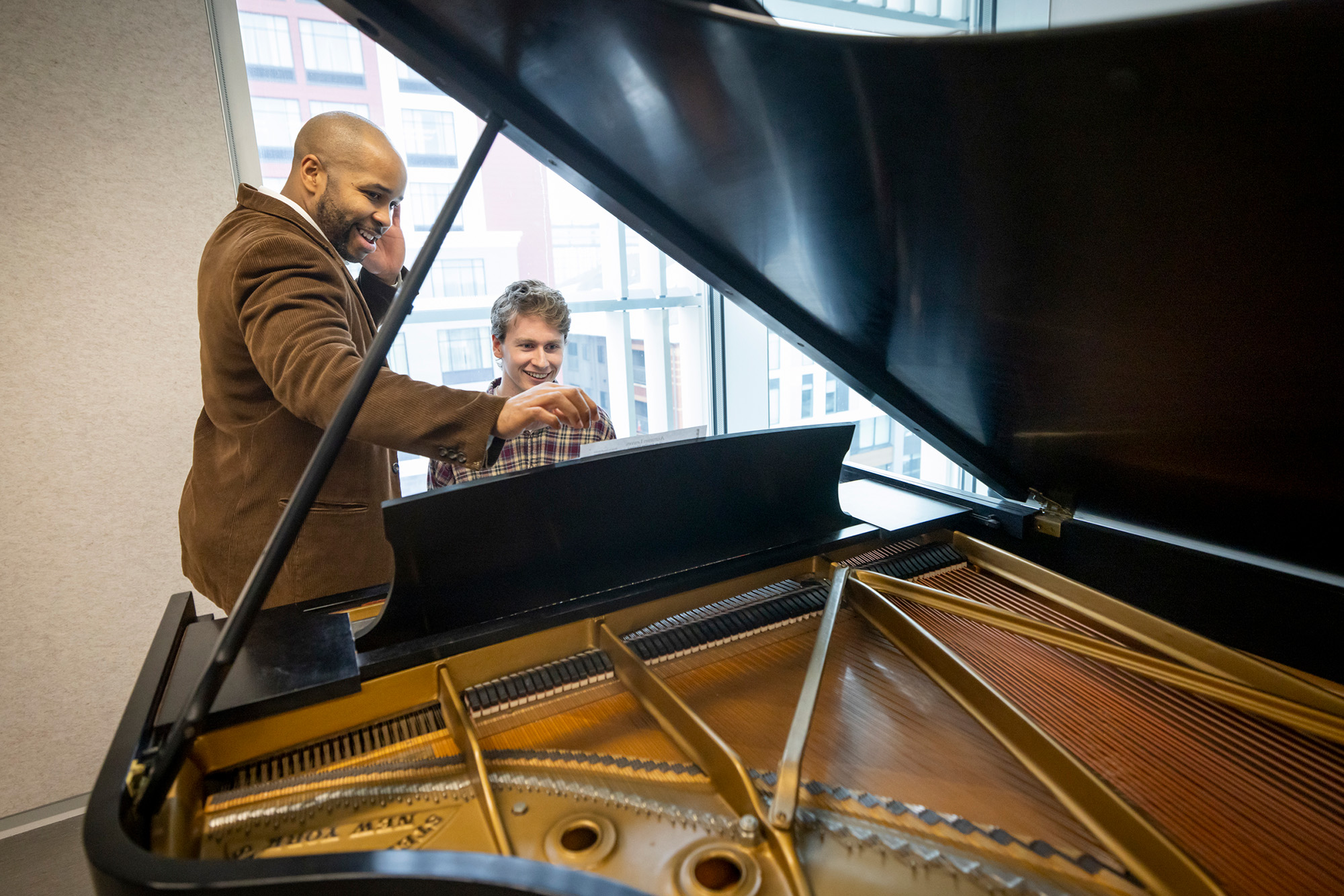 University of Iowa professor William Menefield and UI music student Sean Harken at a piano