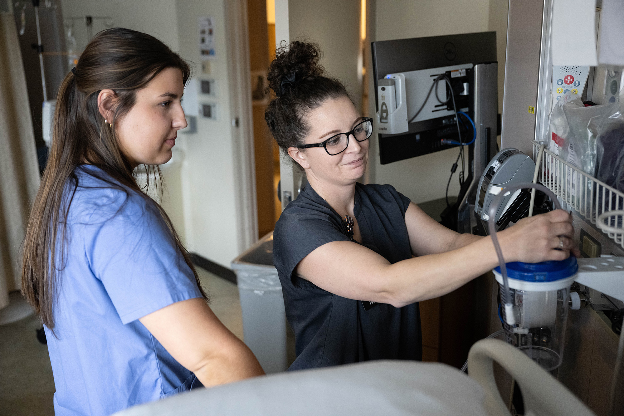 University of Iowa student Alana Gratton and nurse manager Jessica McDaniel working in a hospital