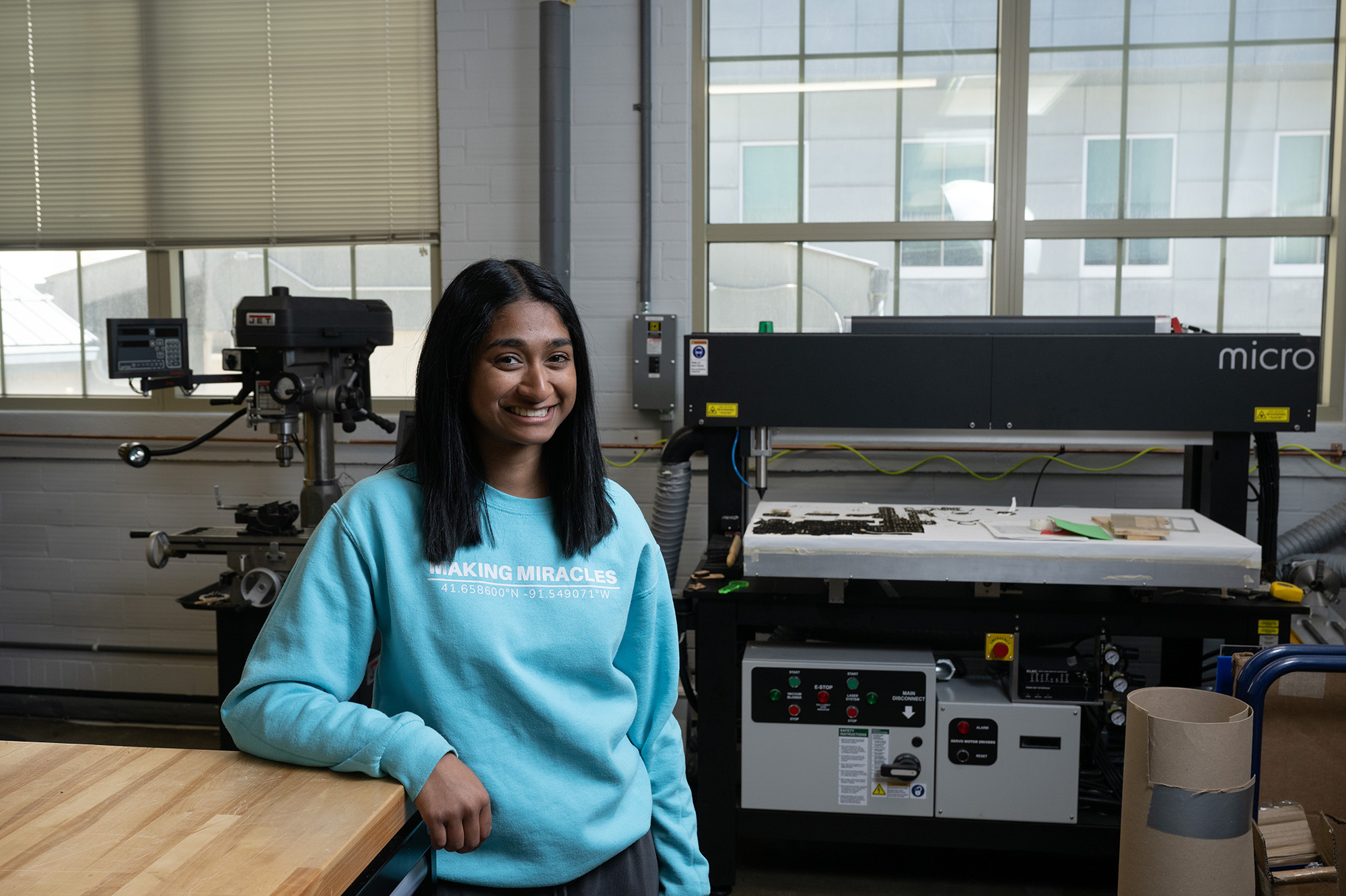 University of Iowa graduate Sushma Santhana standing inside an engineering shop