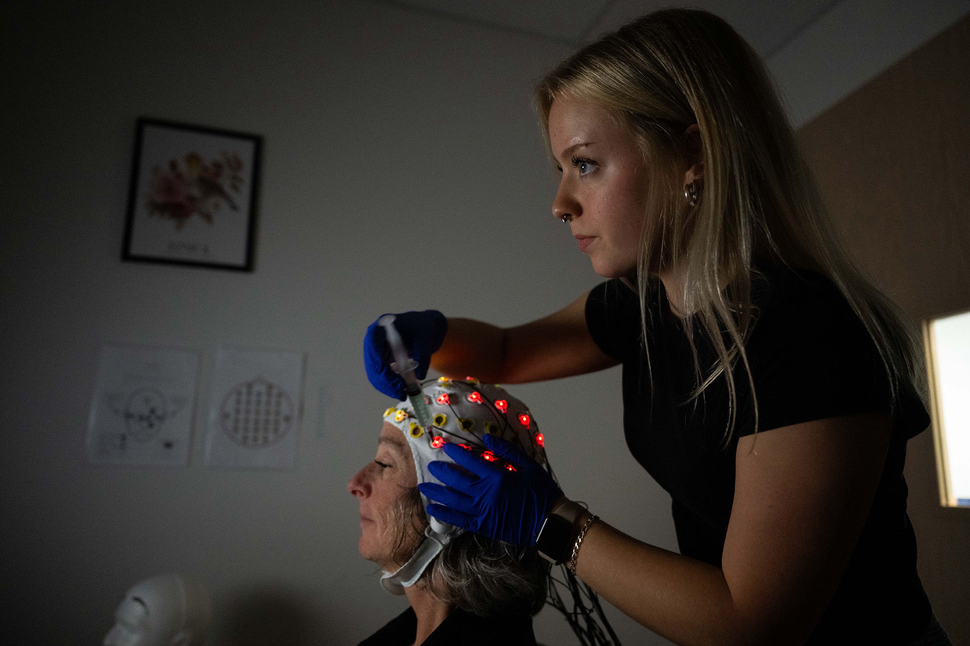 a university of iowa student prepares a subject for a study in the Psychological and Brain Sciences Building