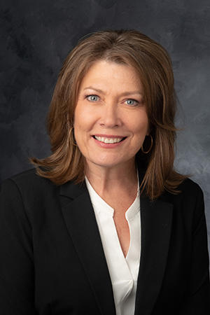 A headshot of a woman smiling