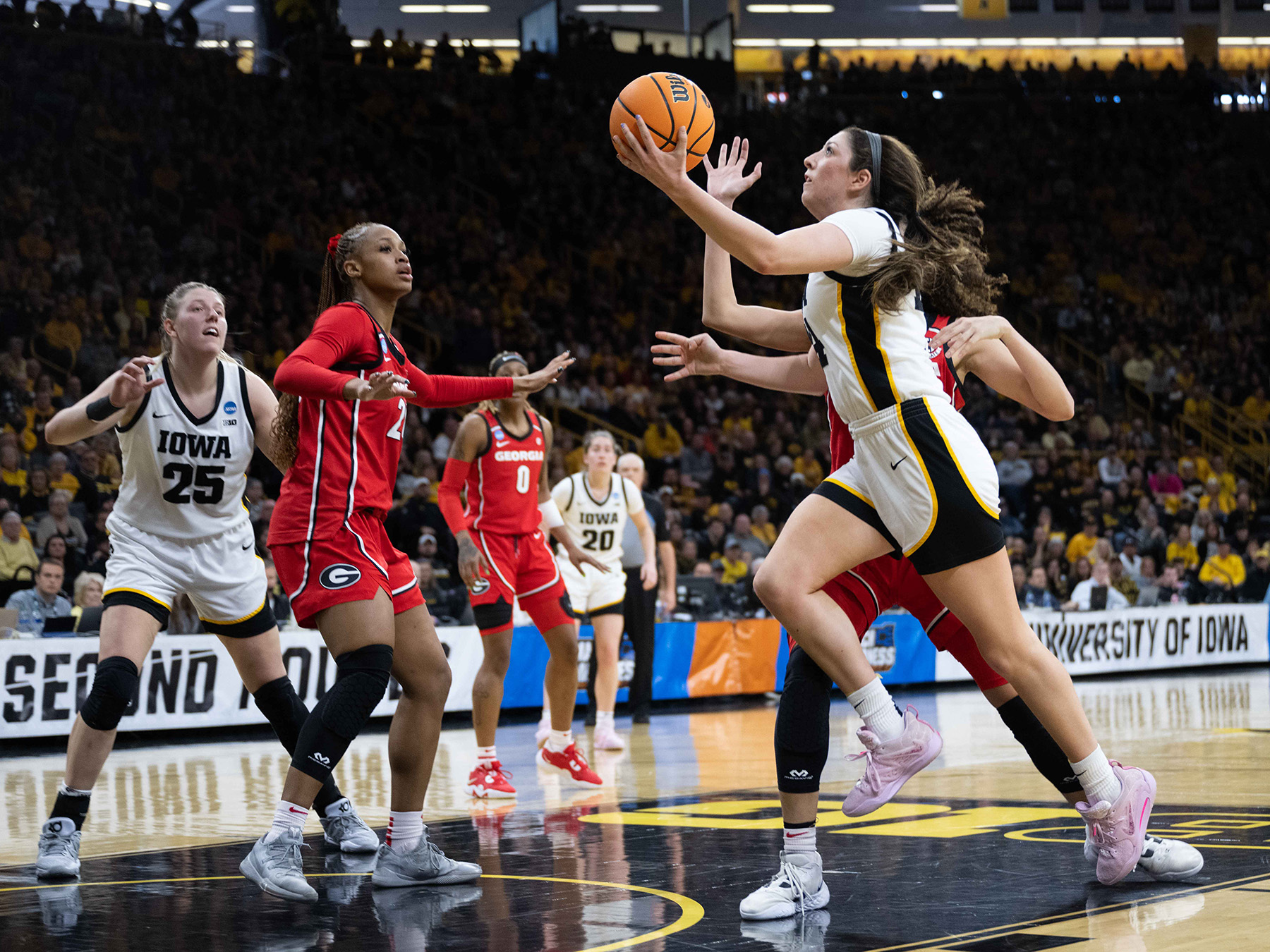 A basketball player going for a layup