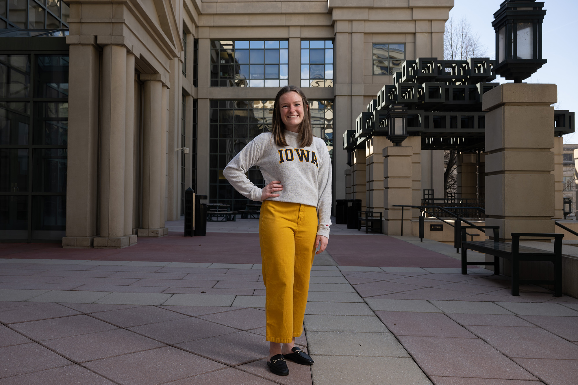 A woman smiling while standing outside of the Pappajohn business building