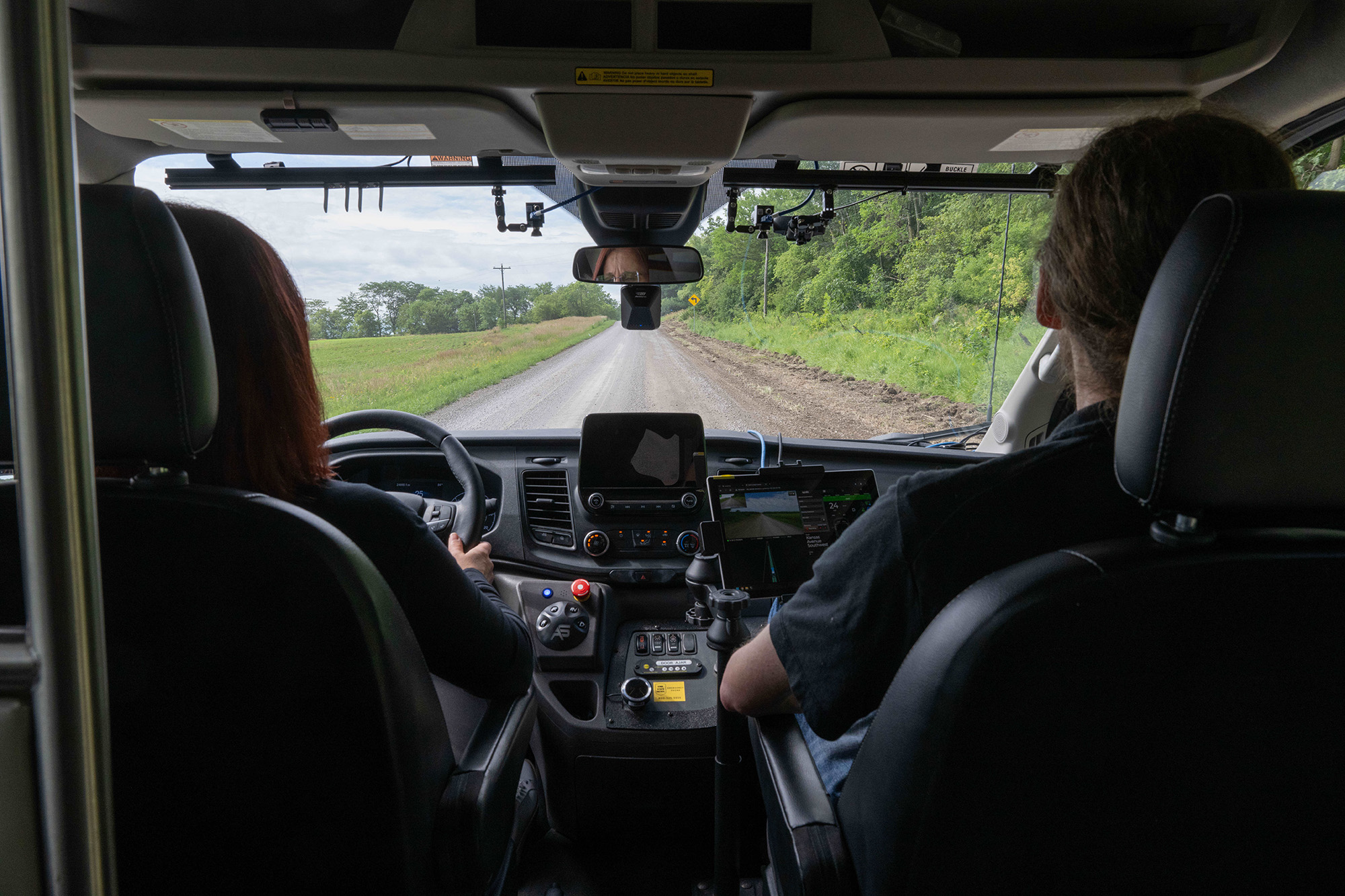 Two people driving down a country road