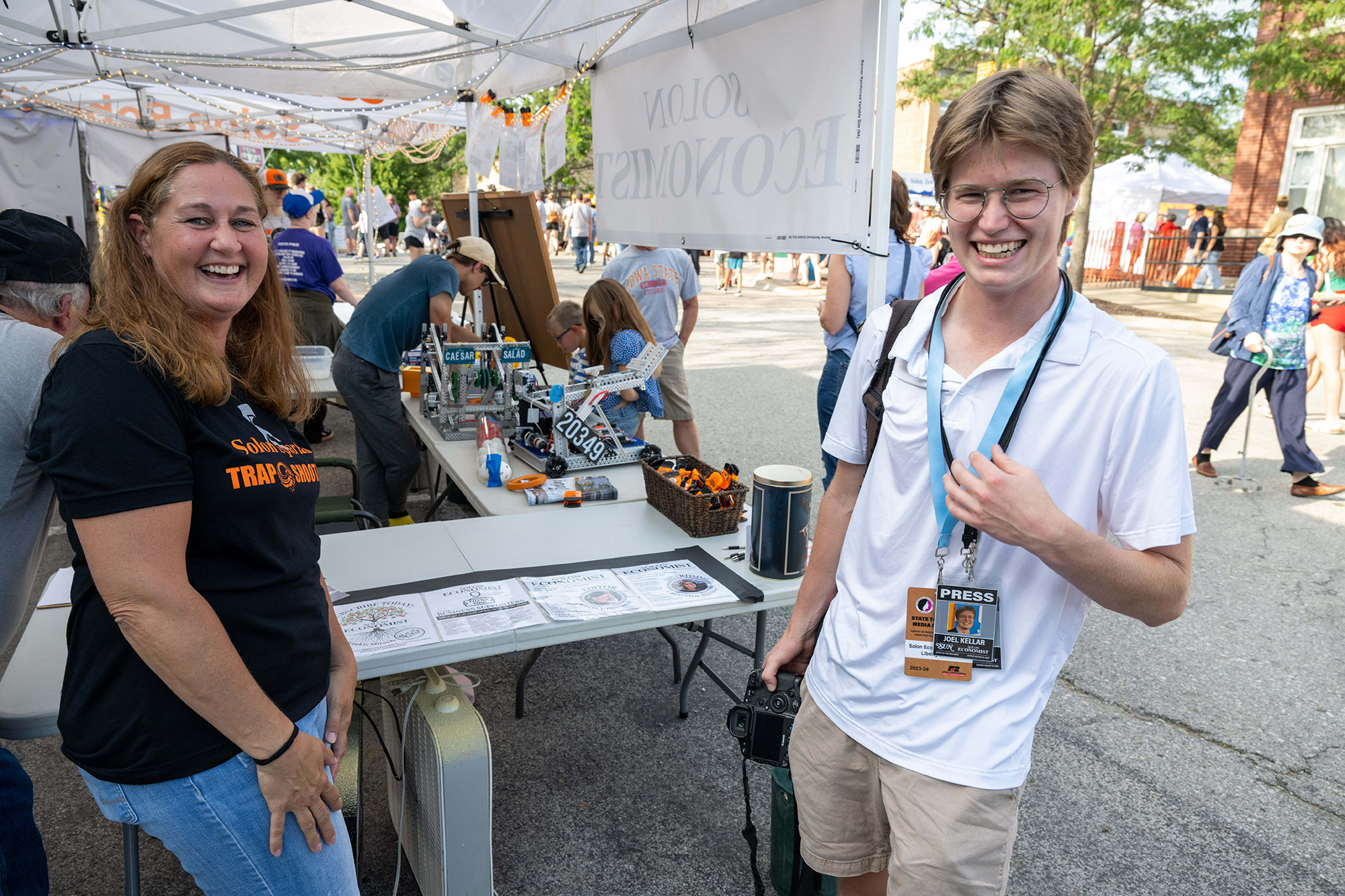 A photographer standing with a community member