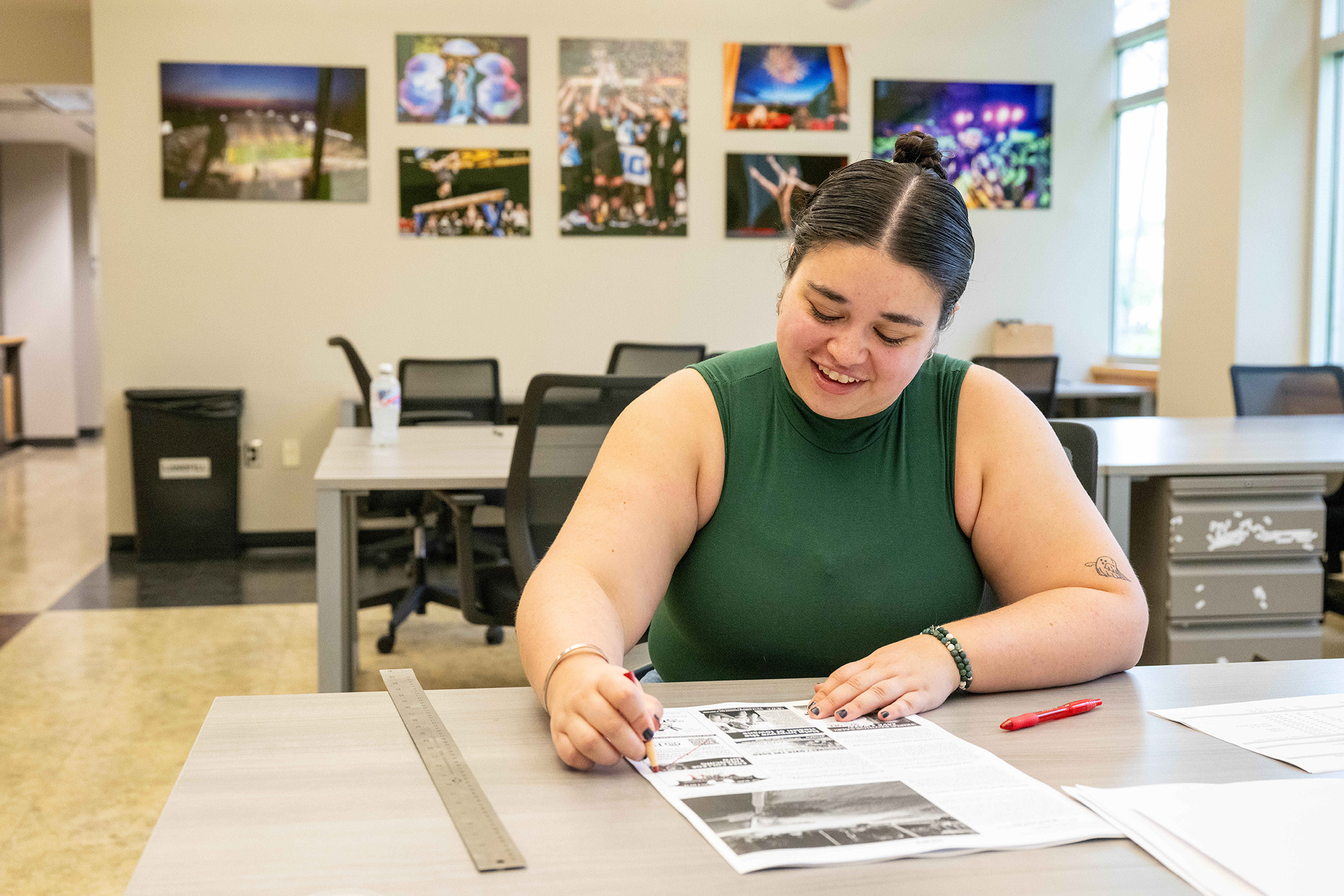 A woman sitting at a desk outlining a paper