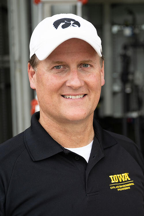 A man smiling wearing an Iowa Hawkeyes hat