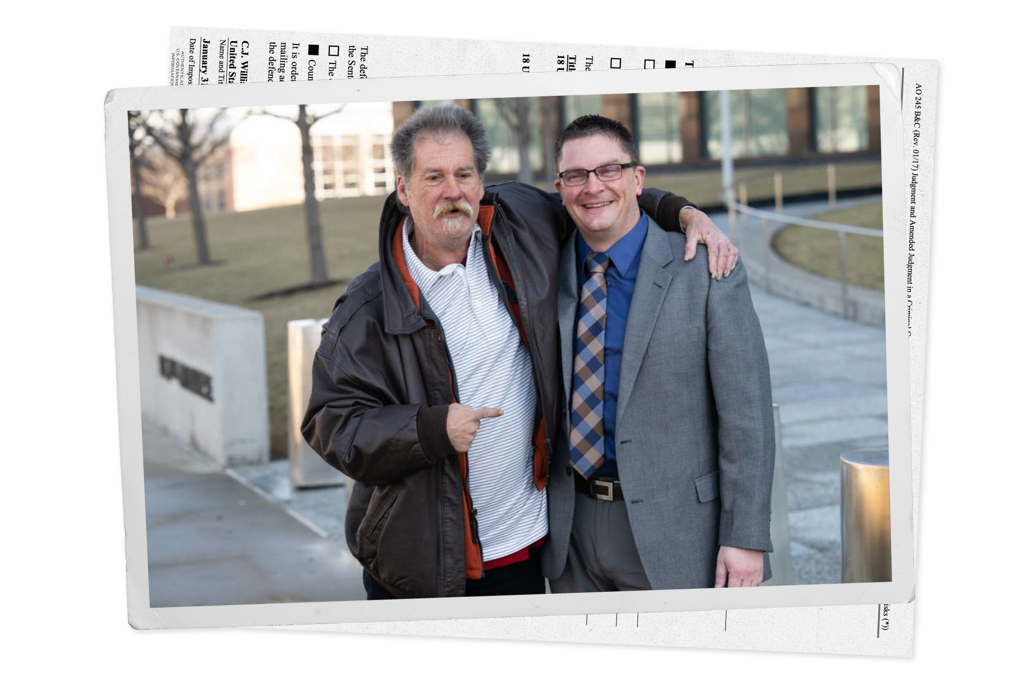 William Woods with his arm around Ian Mallory, smiling and pointing at the detective