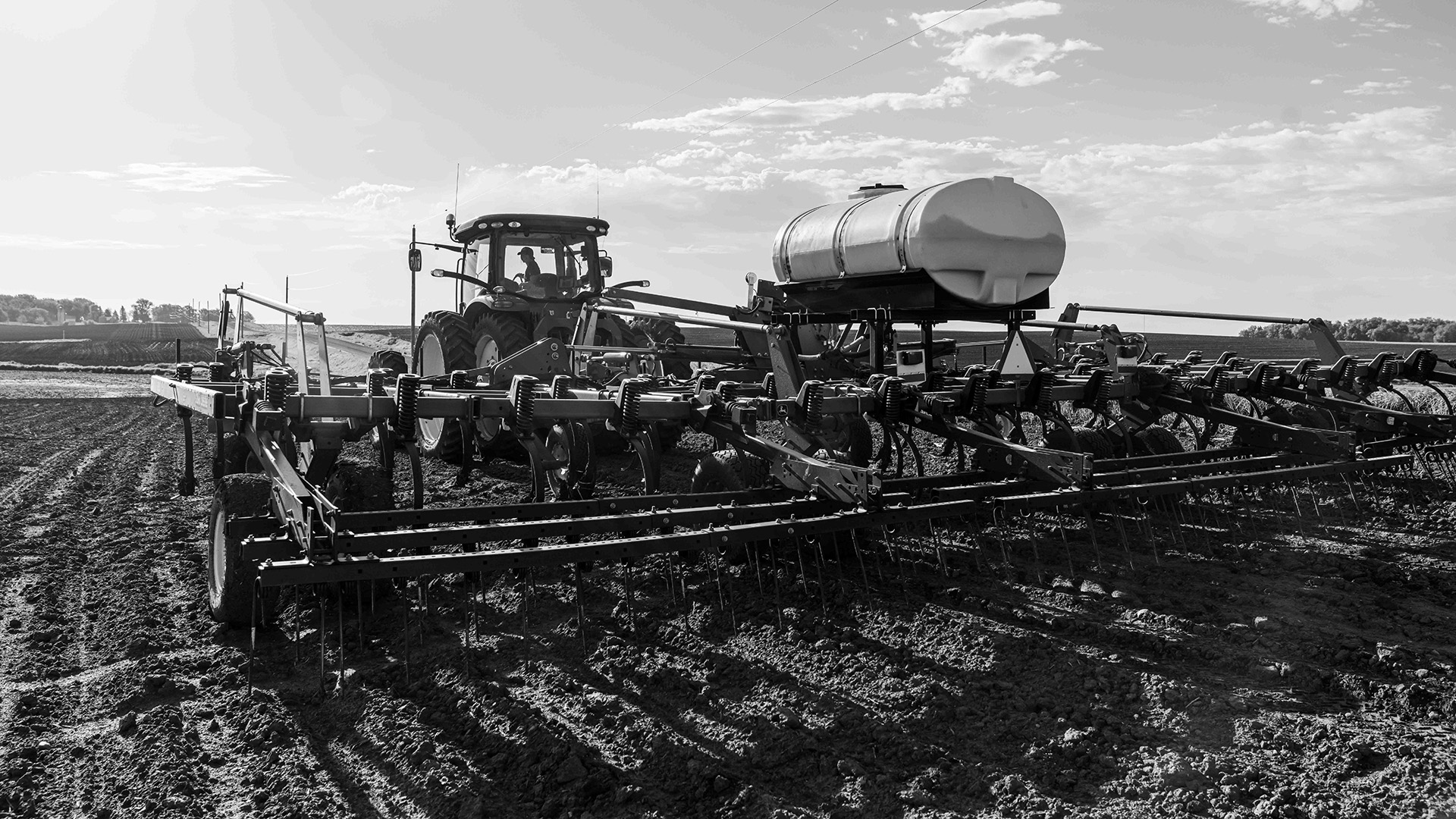 A tractor pulling a plow behind it