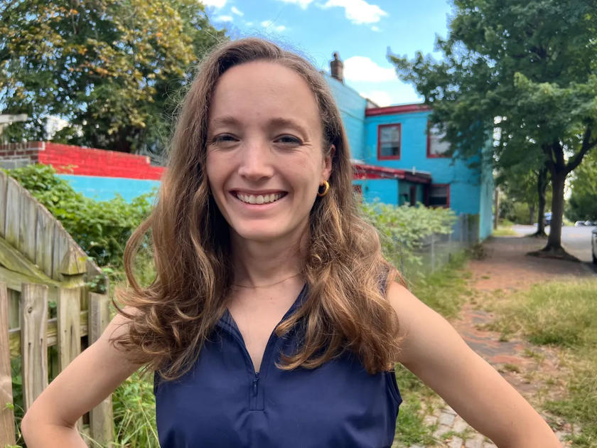 A woman standing outside smiling