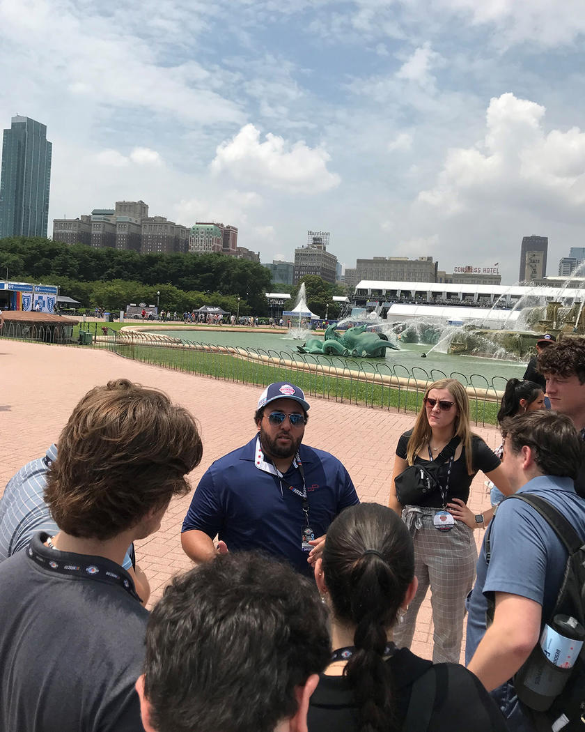 a man speaks to people in an outdoor setting in Chicago