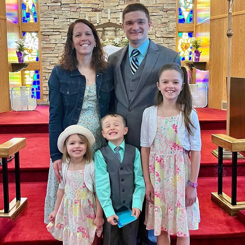 A family standing together in a church