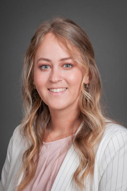 A woman posing for a photo and smiling
