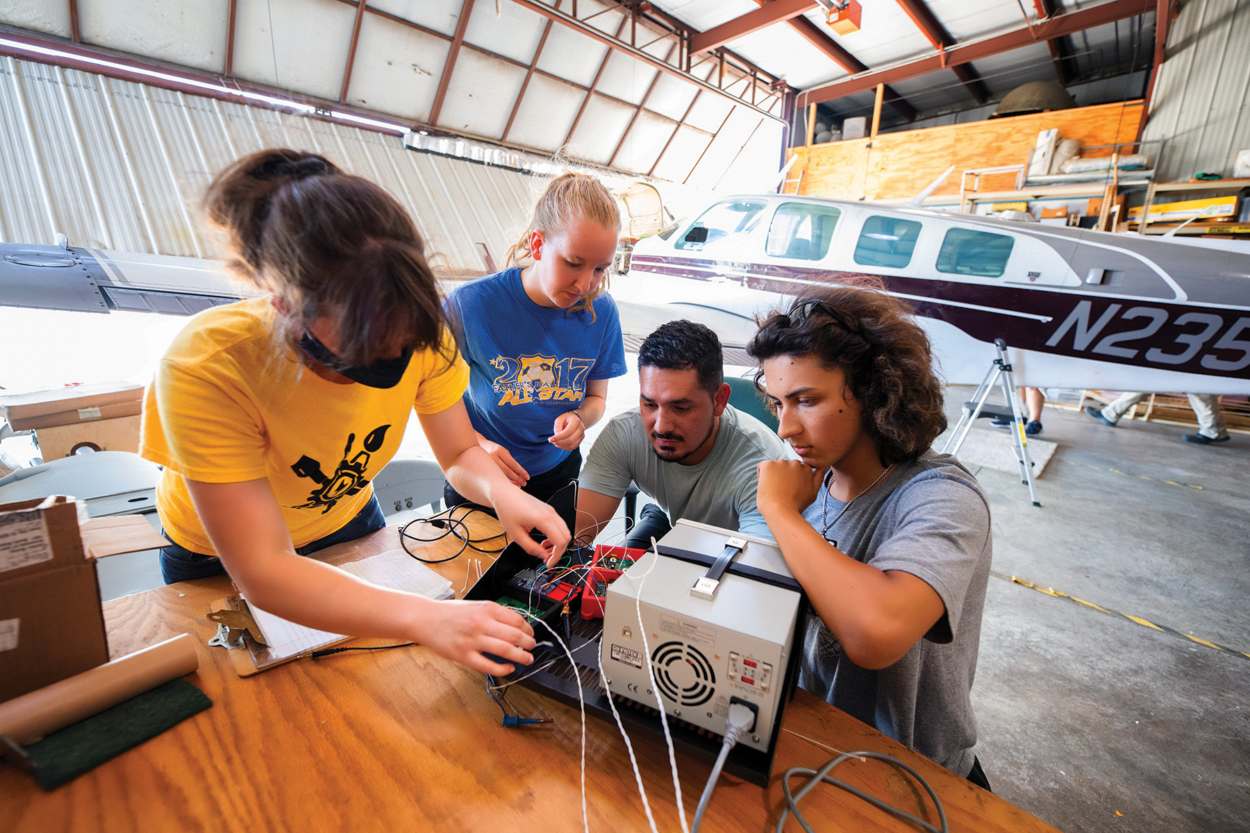 University of Iowa physics and astronomy undergraduate student Tino Smith (right) works with (from left) Raemalin Hancock, Alexa Houck, and Jose Castelblanco at the Operator Performance Laboratory as part of the Edge of Space Academy.