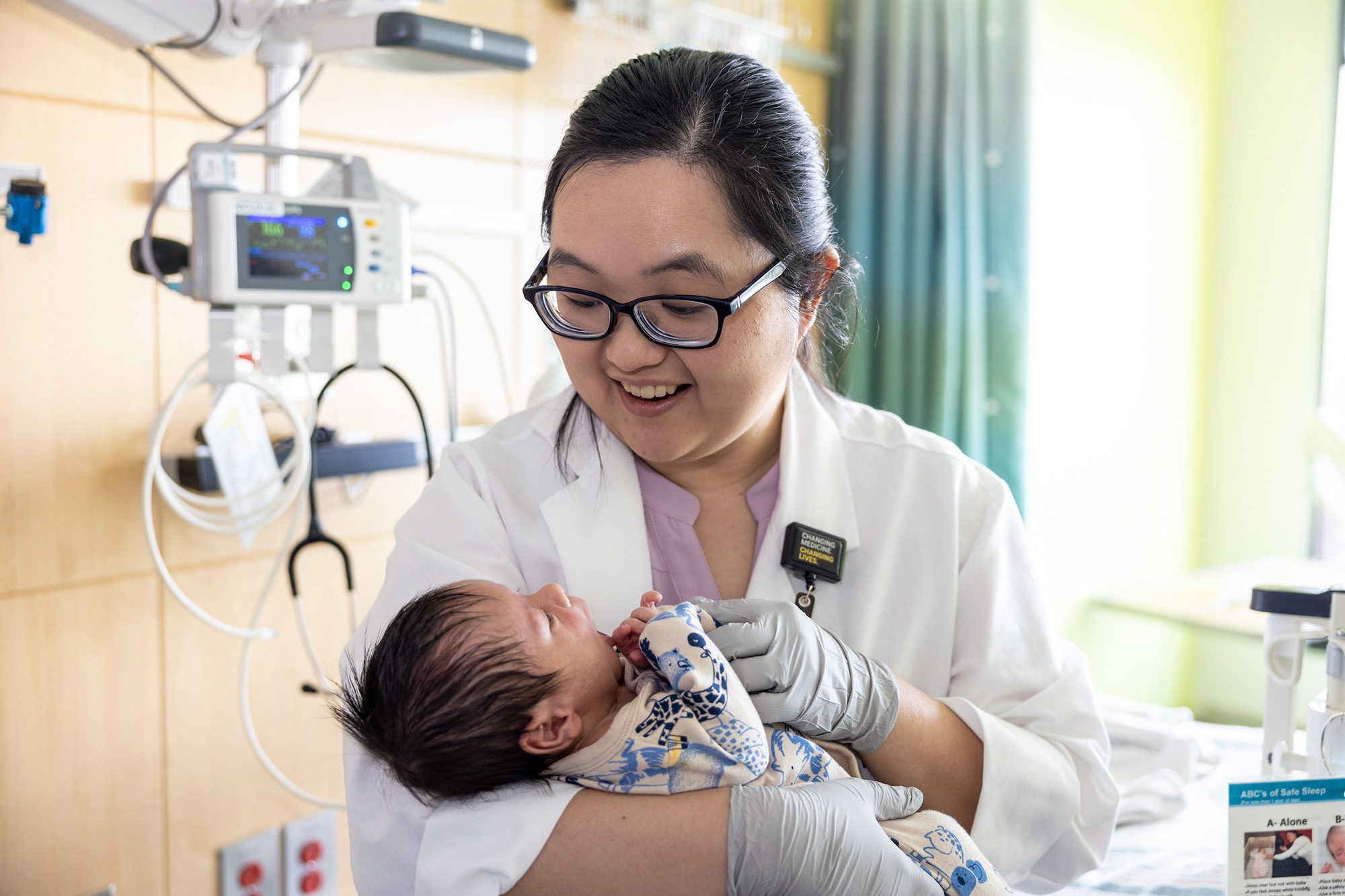 a health care professional holding an infant