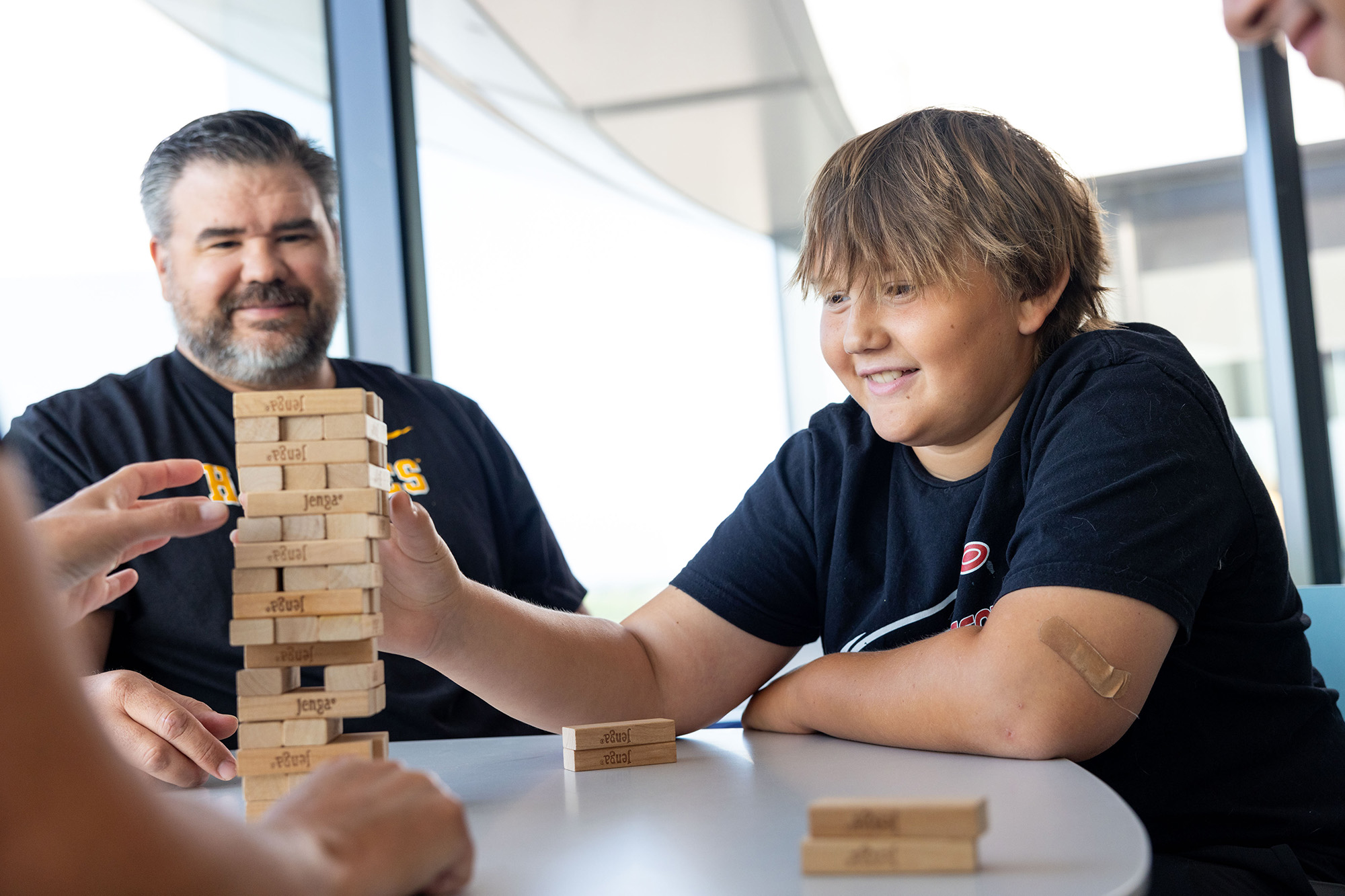 A boy and his dad playing Jenga