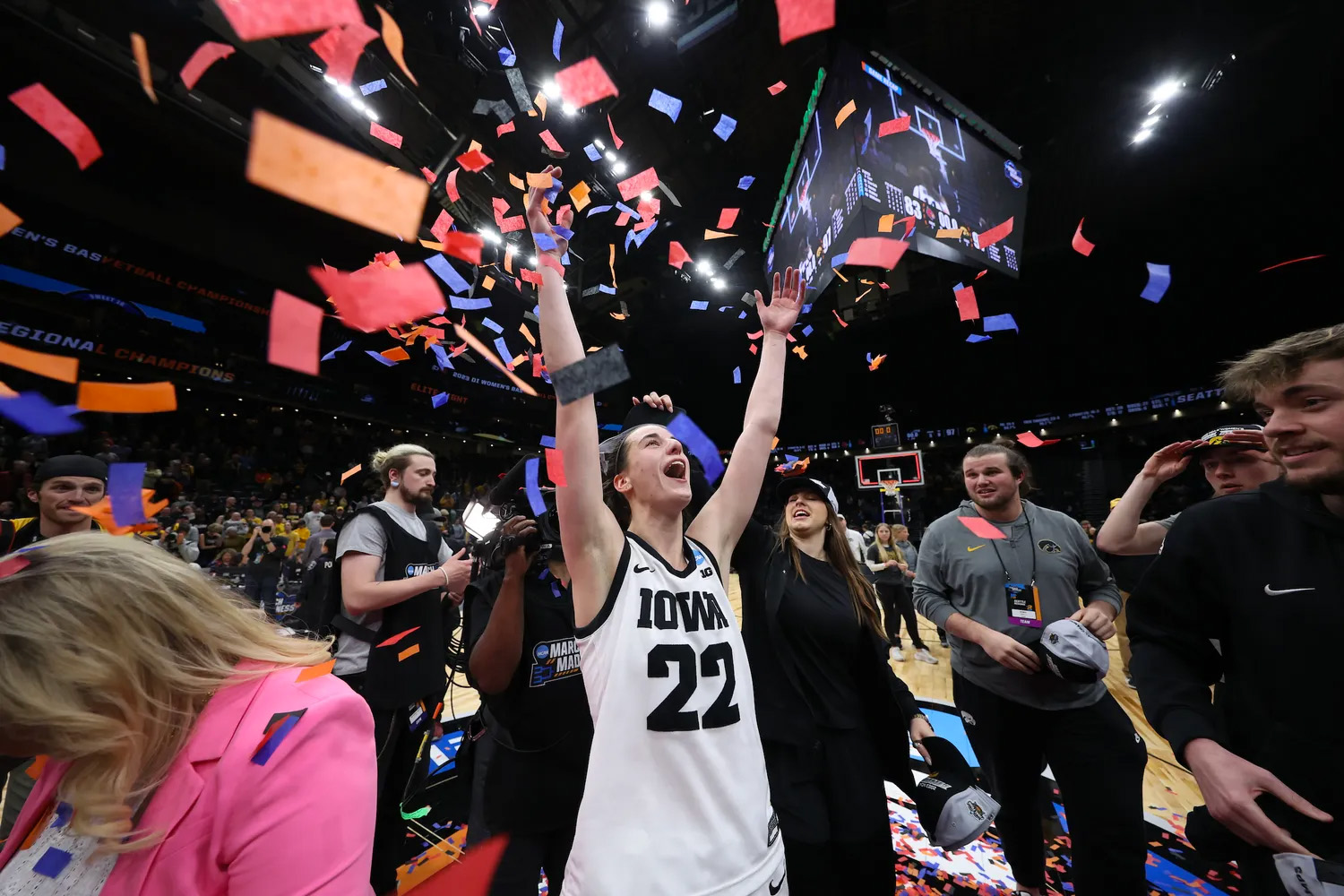 caitlin clark celebrating while confetti falls around her
