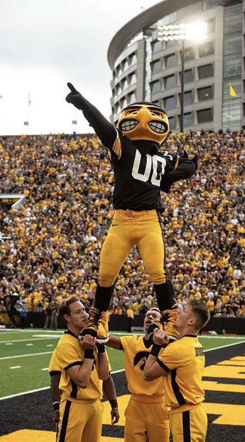 herky and cheerleaders at an iowa football game