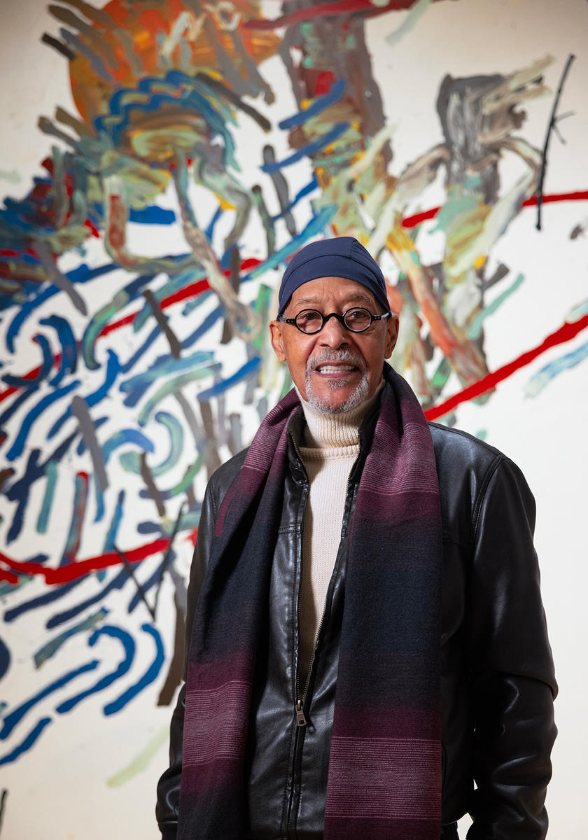A man standing in front of a mural