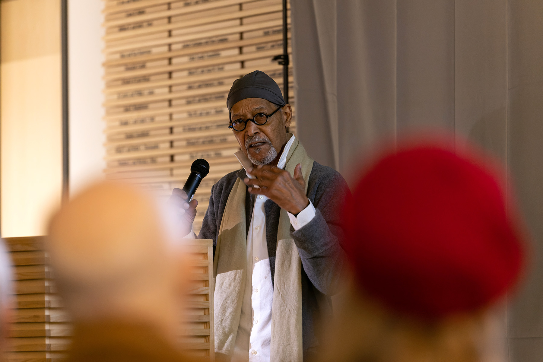 A man speaking into a microphone standing over a crowd