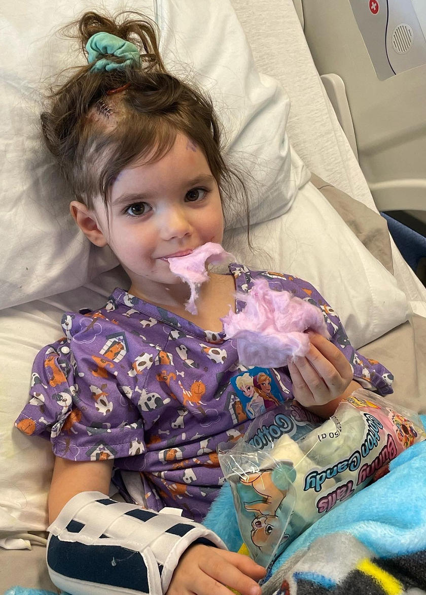 A young girl sitting in a hospital bed