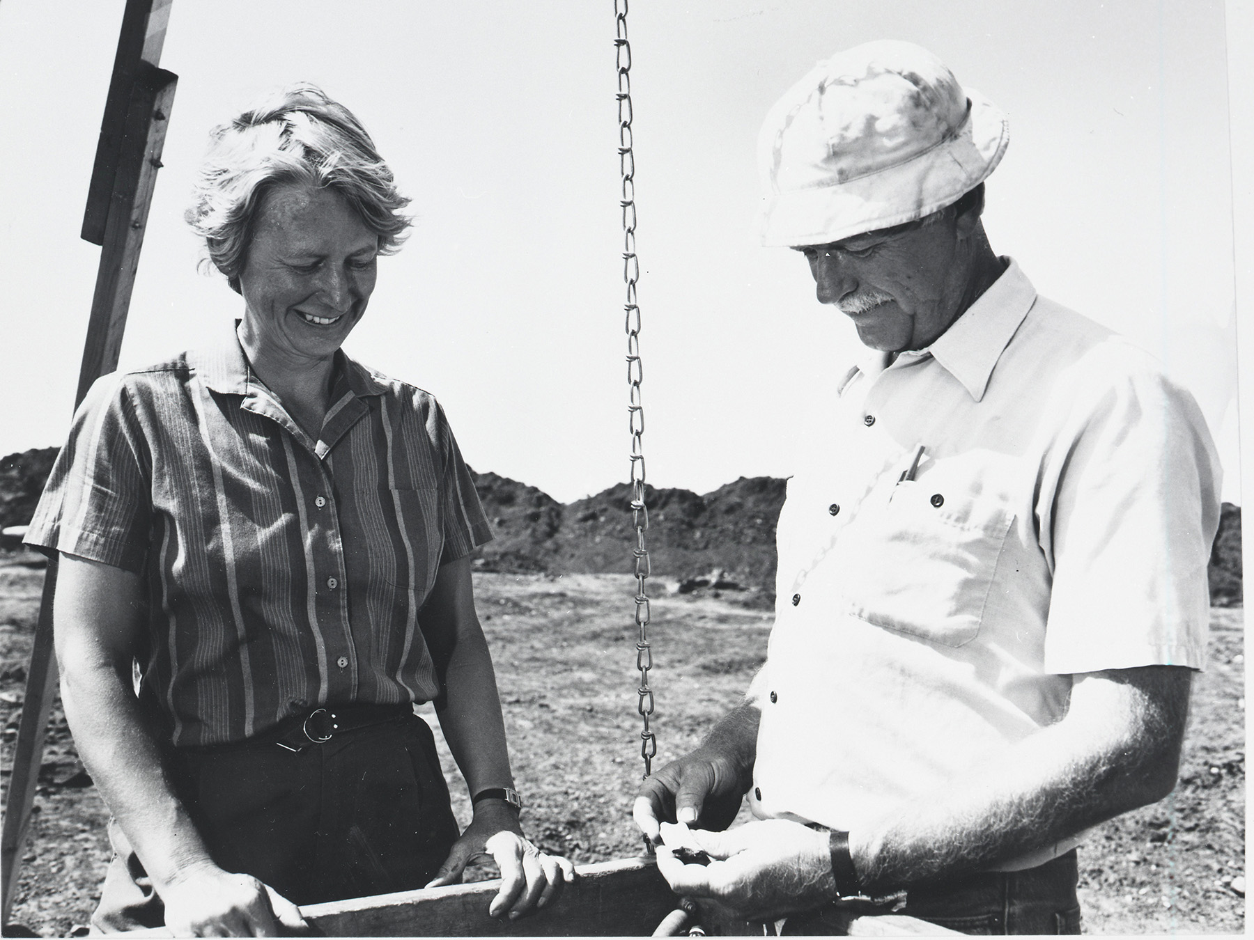 two people working on a dig site together
