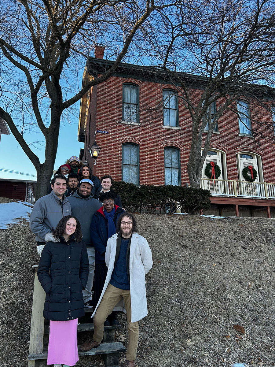 students standing in front of the Alexander Clark house in Muscatine
