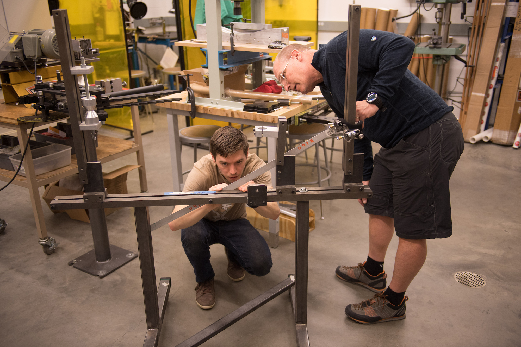 two people taking measurements for a project