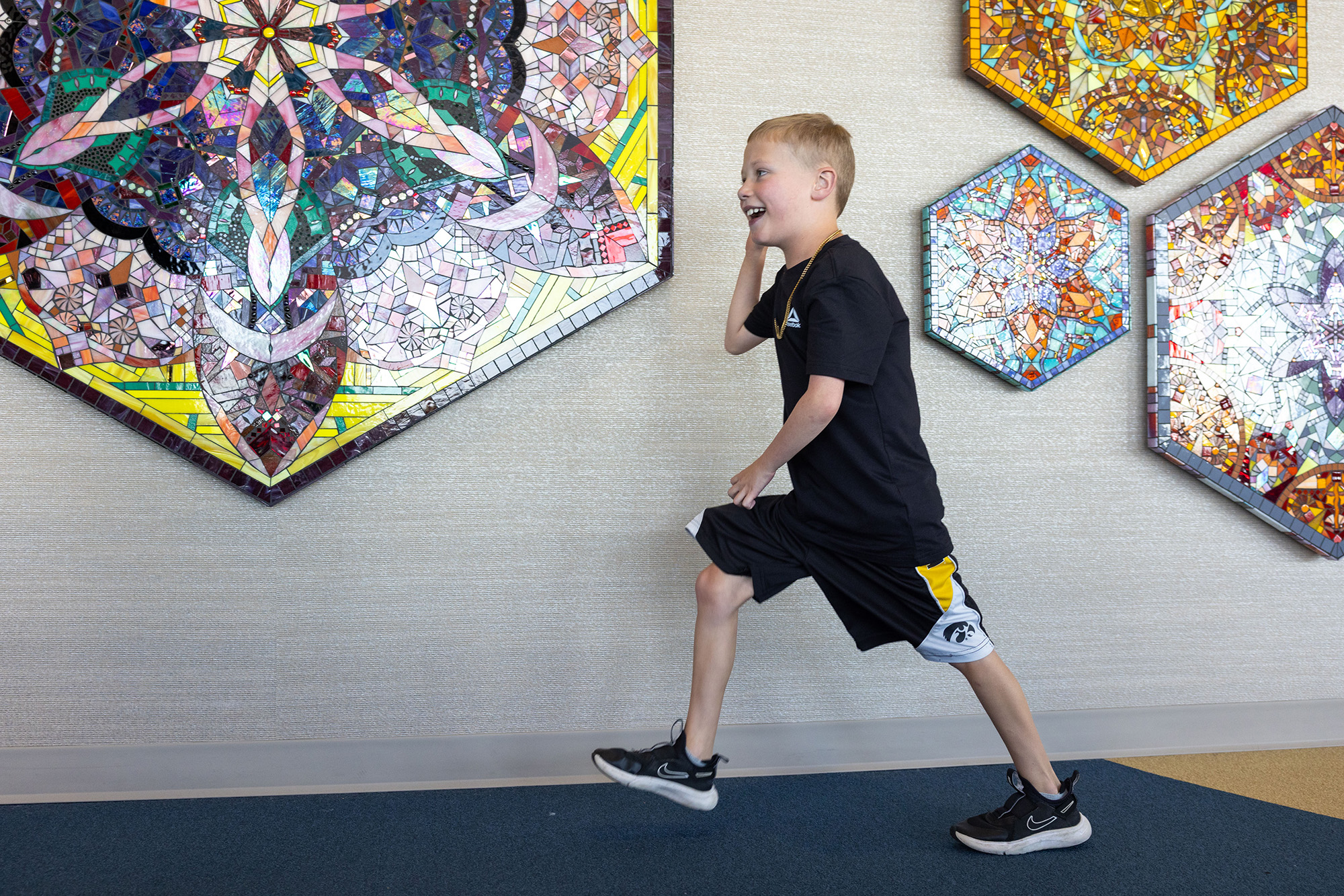 A boy running through a hallway